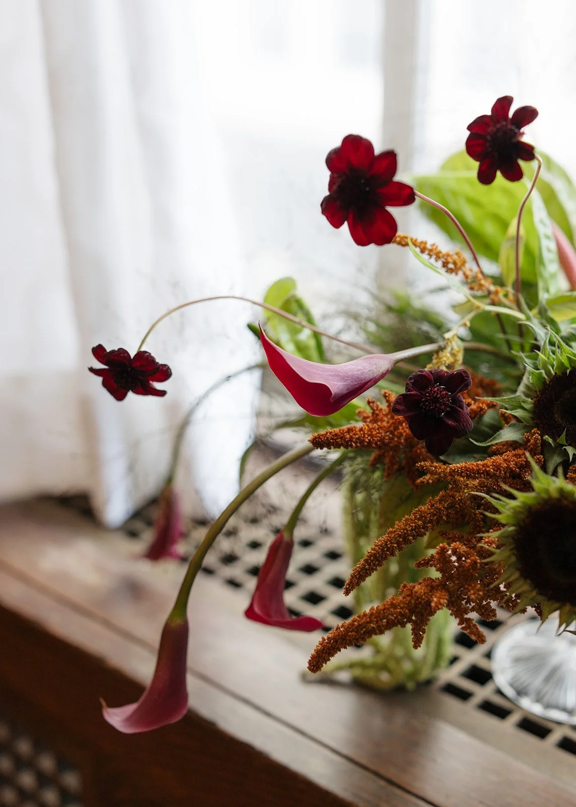 Modern chic november fall wedding downtown hotel kansas city orchids wedding cocktail hour bar arrangement anthurium sunflower moss mound the cottage rose kansas city wedding florist crossroads