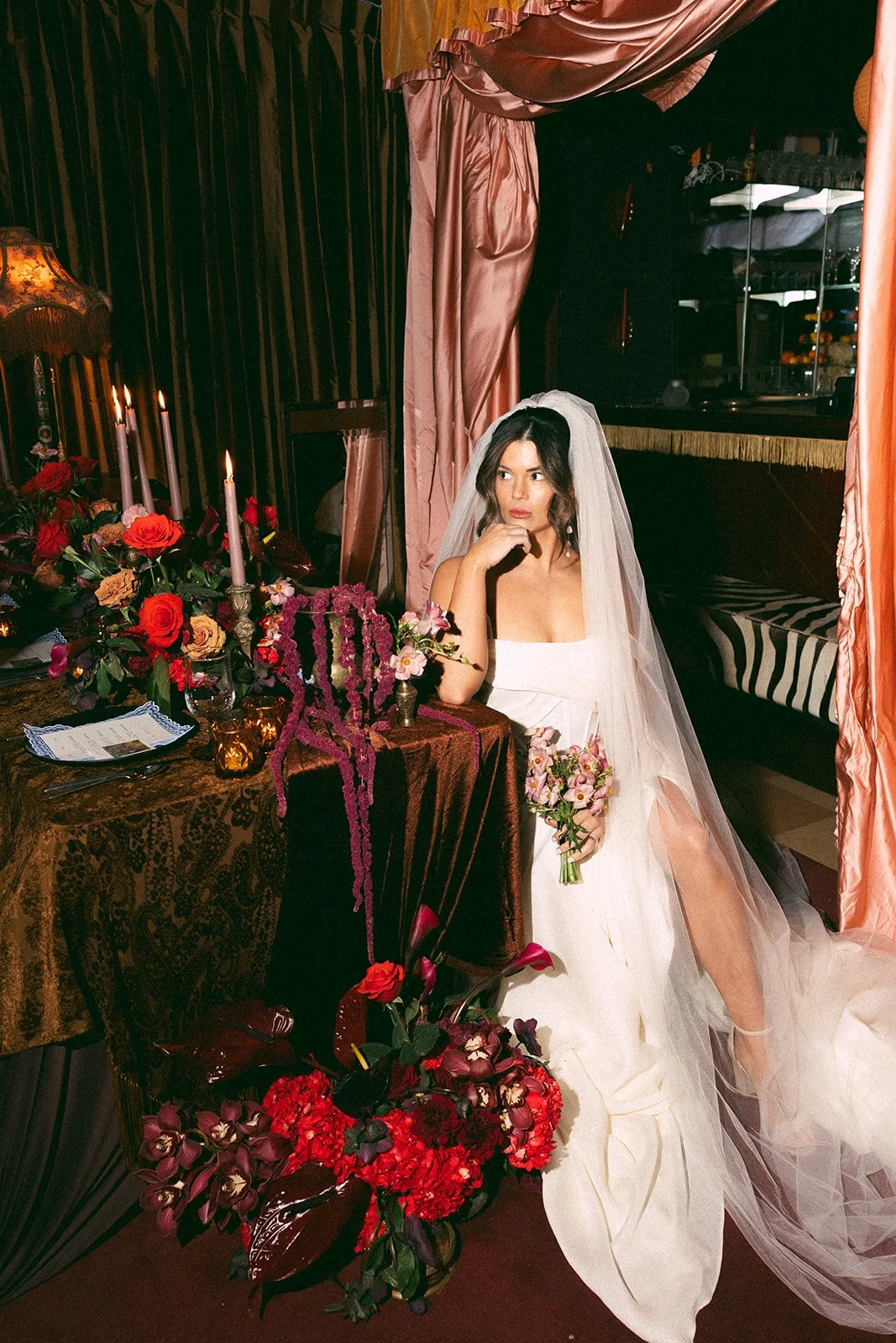 Vintage maximalist more is more wedding inspiration full lush florals pop of red modern corset bridal look le lounge kansas city wedding florist the cottage rose crossroads spring wedding decor brown fabric orchids amaranth bride kc fringe