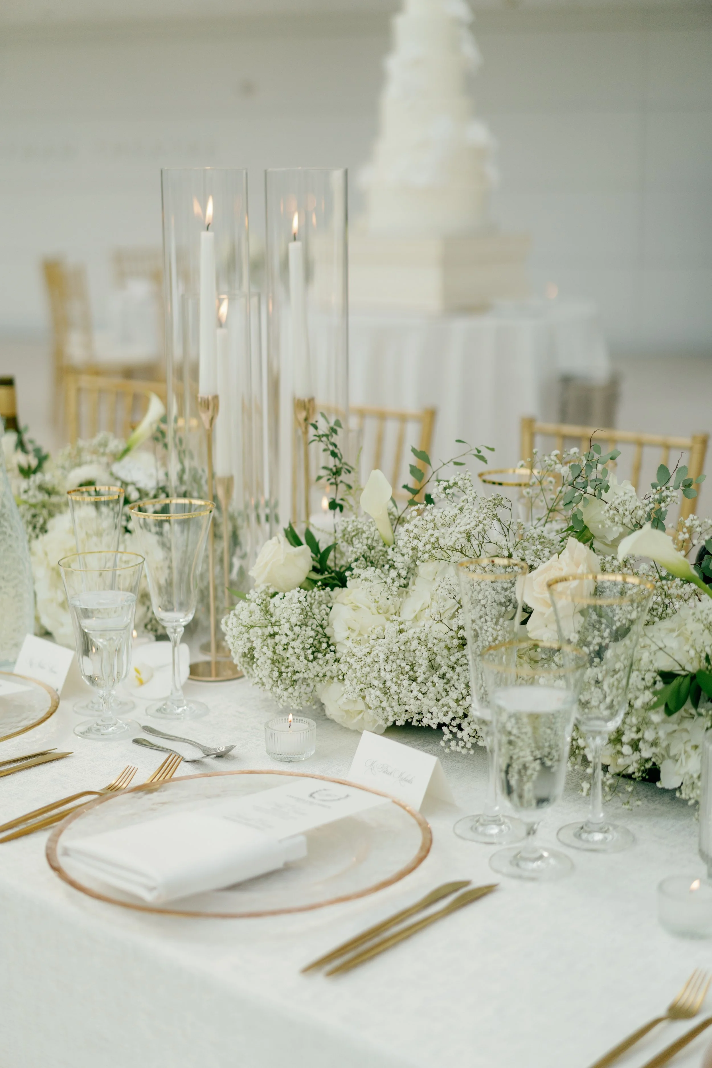 Modern chic spring wedding kauffman center for the performing arts cloud dancer inspiration head table garland tall centerpieces low floral arrangement babys breath orchids calla lilies the cottage rose kansas city wedding florist crossroads