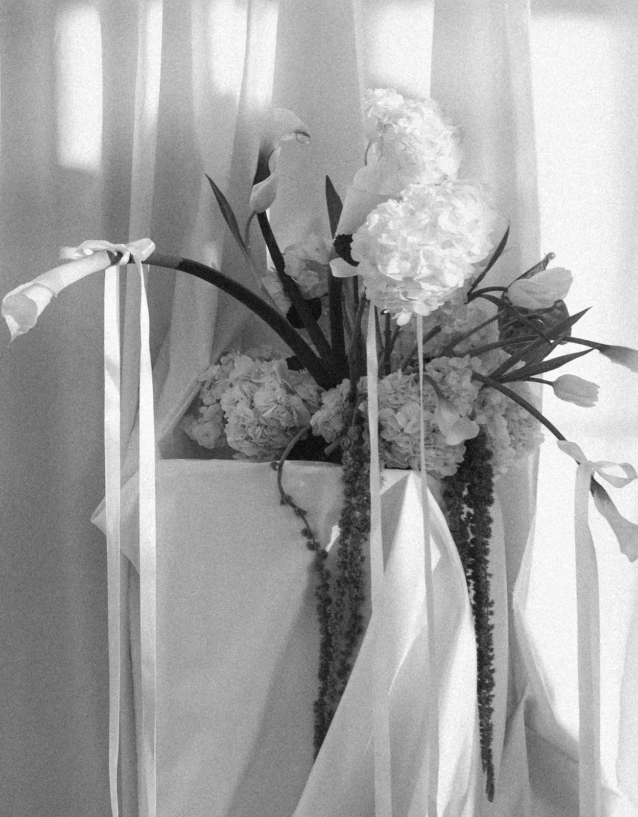 Modern chic branding shoot for an interior designer white and green flowers amaranth calla lilies anthurium hydrangea the cottage rose kansas city wedding florist crossroads pedestal floral installation draped fabric white ribbons bows