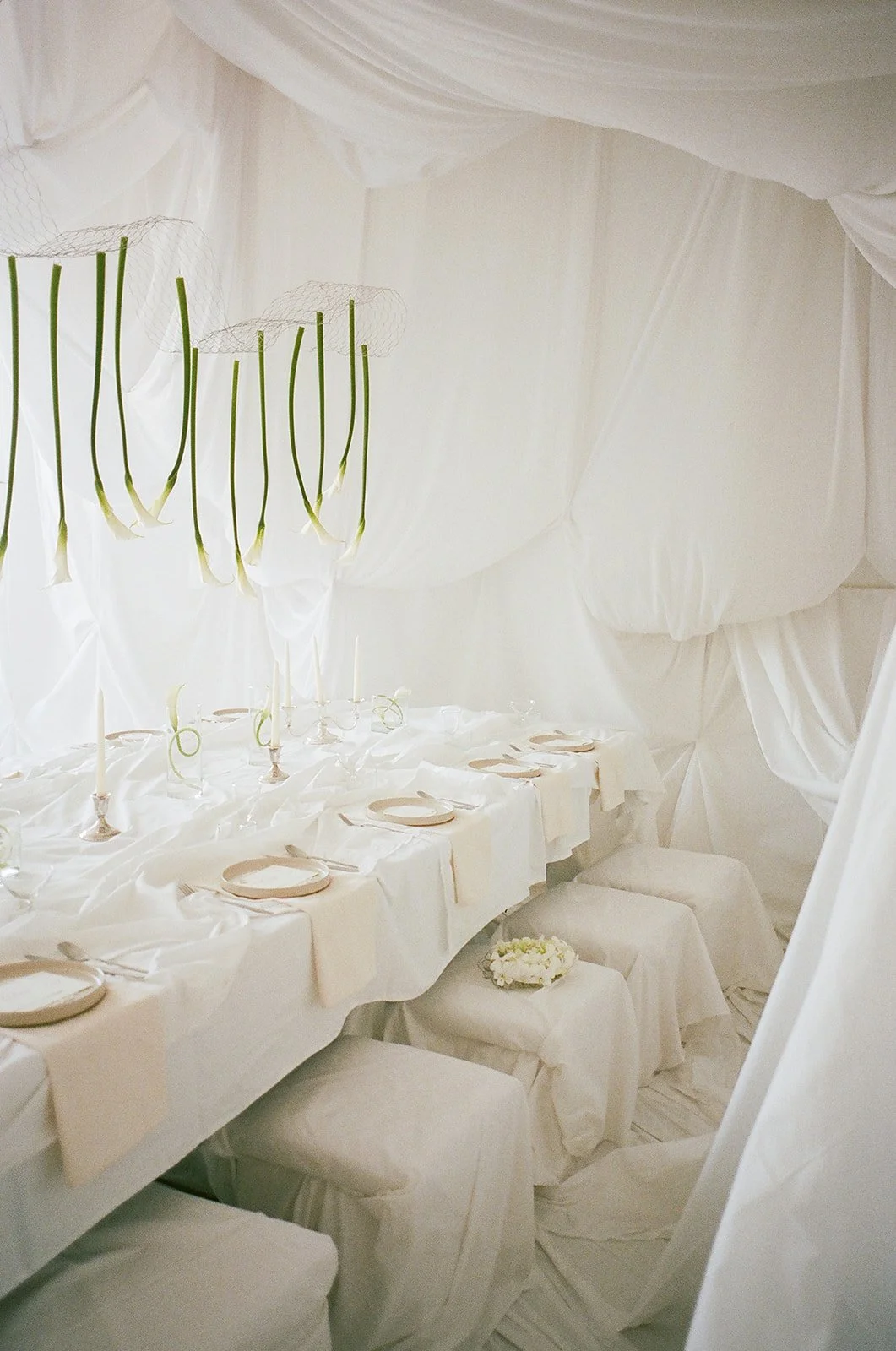 Chic Modern Baby Shower in a Cloud with layers of white draped fabric, simple calla lily centerpieces,  silver candlesticks, hanging floral installation the cottage rose kansas city florist crossroads