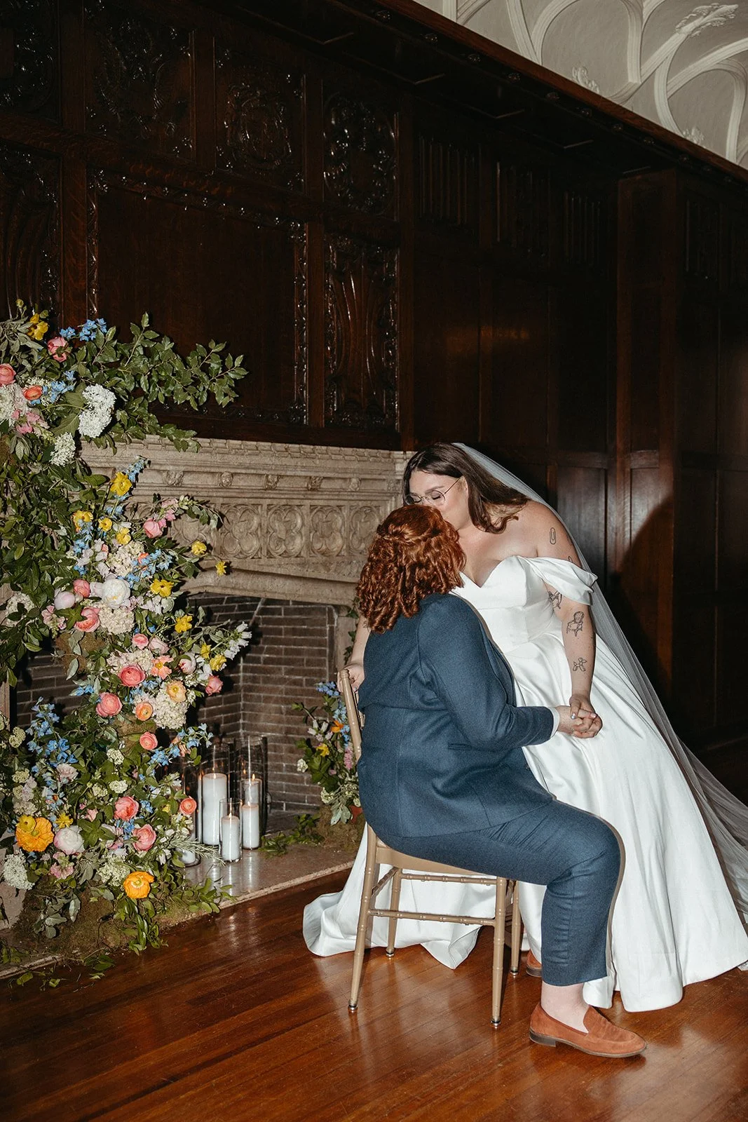 candlelit whimiscal spring garden wedding pastel color palette same sex wedding ceremony fireplace floral installation aisle flowers downtown kc hotel kansas city the cottage rose kansas city wedding florist crossroads