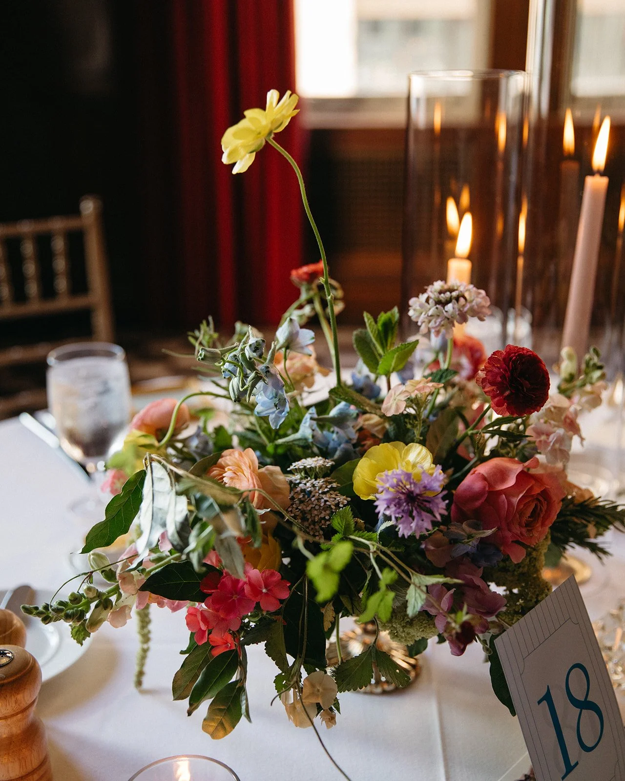 candlelit whimiscal spring garden wedding pastel color palette same sex wedding reception table floral centerpieces downtown kc hotel kansas city the cottage rose kansas city wedding florist crossroads