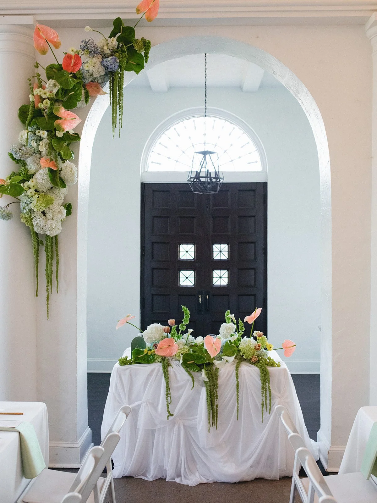 Sculptural modern spring wedding pedestal floral installation anthurium amaranth midtown la villa spring flowers the cottage rose kansas city wedding florist crossroads ceremony decor hanging floral installation sweetheart table