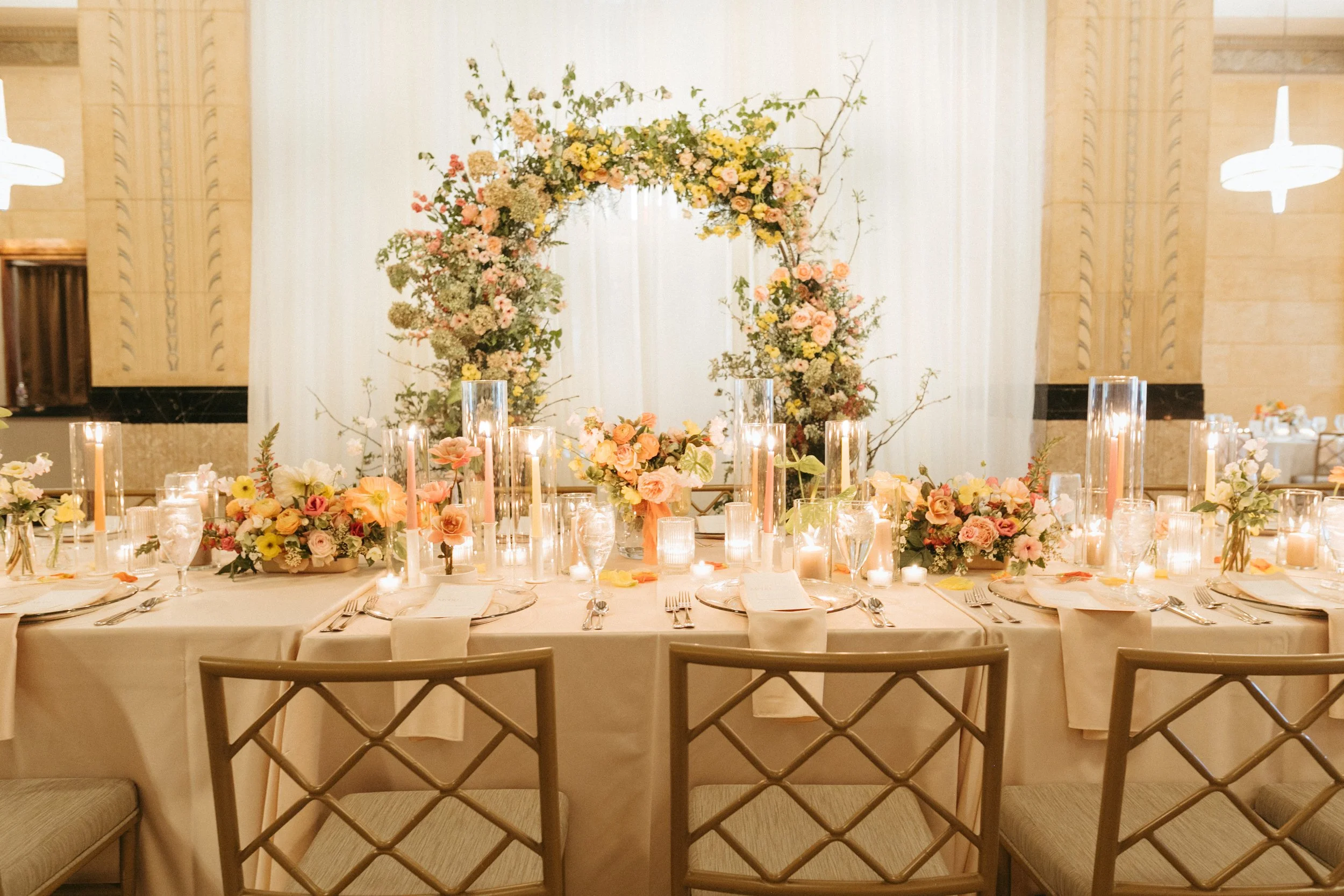 reception flowers large lush floral arch ceremony backdrop head table flowers and candlesmodern garden wedding flowers  the grand hall downtown kc the cottage rose kansas city wedding florist crossroads