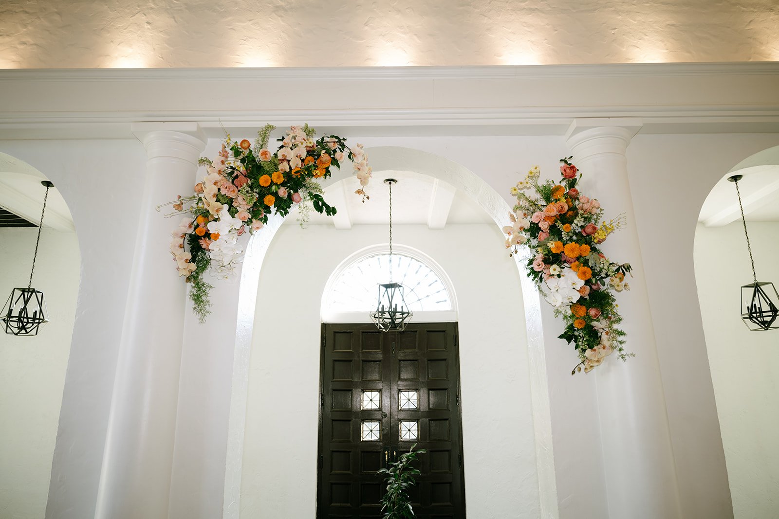 colorful flower filled october wedding in midtown kansas city la villa bridal bouquet wedding bouquet wedding flowers orchids garden roses ranunculus the cottage rose kansas city wedding florist crossroads ceremony hanging flower arrangement