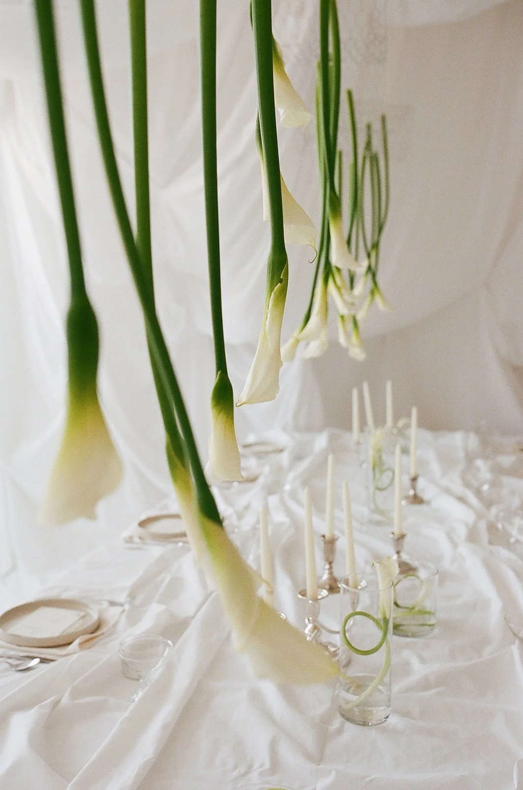 Chic Modern Baby Shower in a Cloud with layers of white draped fabric, simple calla lily centerpieces,  silver candlesticks, hanging floral installation the cottage rose kansas city florist crossroads