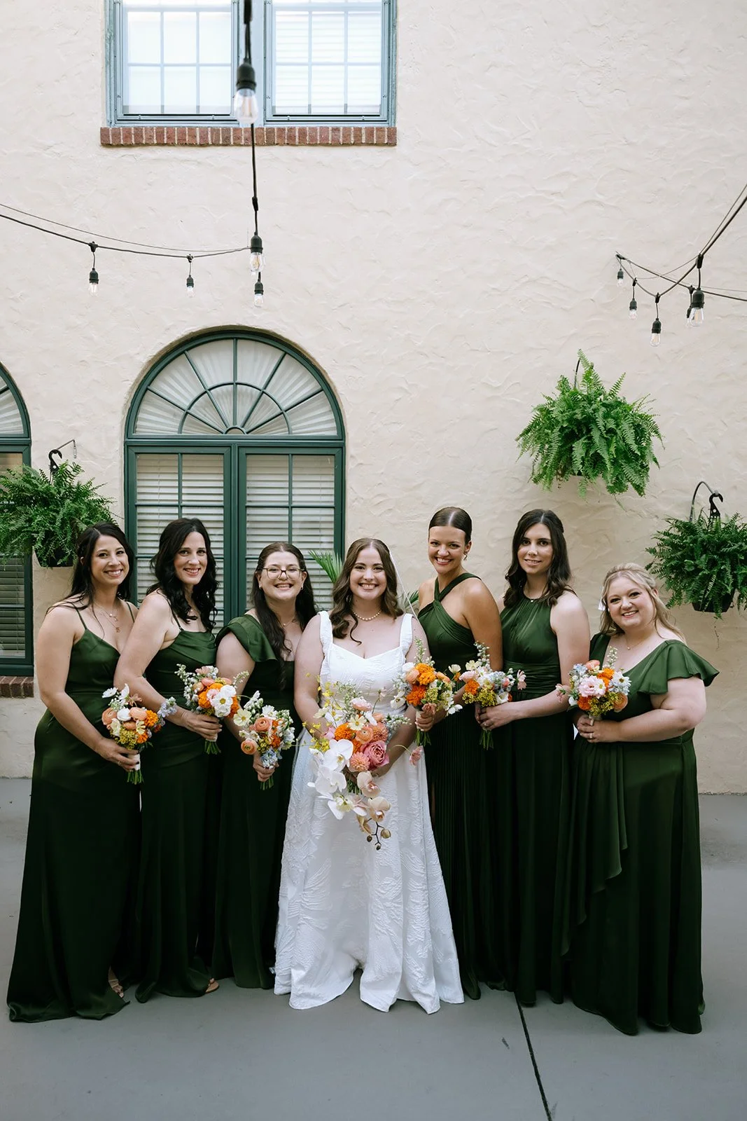 colorful flower filled october wedding in midtown kansas city la villa bridal bouquet wedding bouquet wedding flowers orchids garden roses ranunculus the cottage rose kansas city wedding florist crossroads bride and bridesmaids green dresses