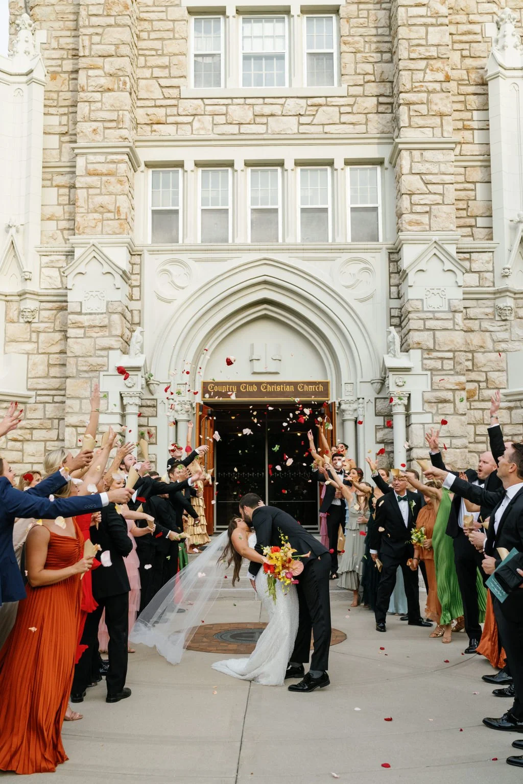Modern eclectic luxury wedding on the lawn at liberty memorial greenhouse tent wedding outdoor reception fall wedding decor october the cottage rose kansas city wedding florist crossroads bride groom colorful orchid bridal bouquet ceremony exit petal