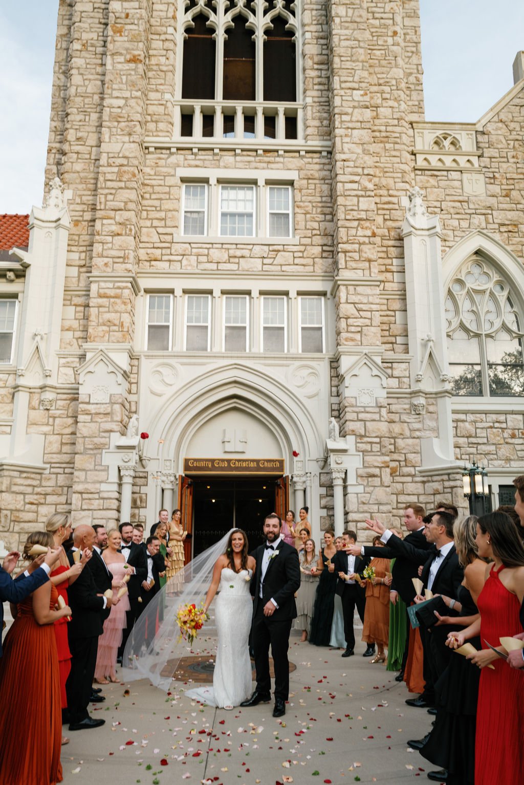 Modern eclectic luxury wedding on the lawn at liberty memorial greenhouse tent wedding outdoor reception fall wedding decor october the cottage rose kansas city wedding florist crossroads bride groom colorful orchid bridal bouquet ceremony exit petal