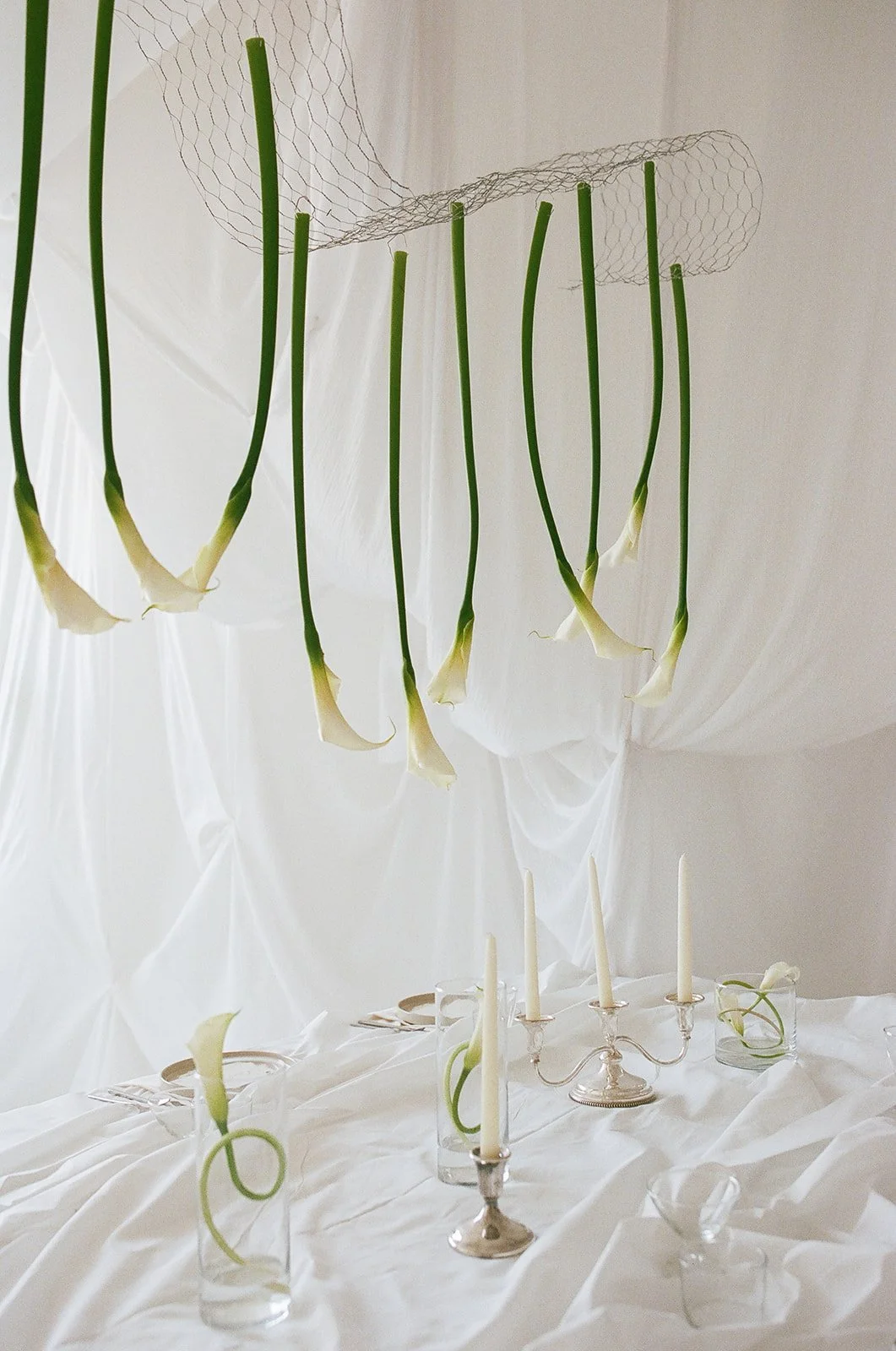 Chic Modern Baby Shower in a Cloud with layers of white draped fabric, simple calla lily centerpieces,  silver candlesticks, hanging floral installation the cottage rose kansas city florist crossroads