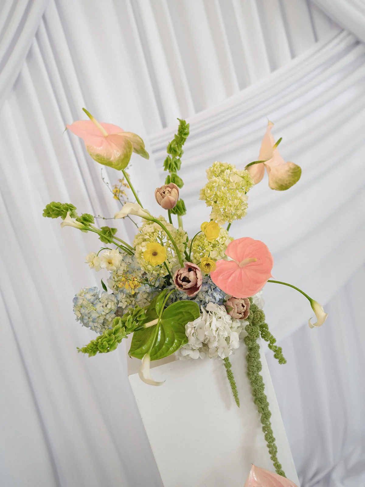 Sculptural modern spring wedding pedestal floral installation anthurium amaranth midtown la villa spring flowers the cottage rose kansas city wedding florist crossroads ceremony decor