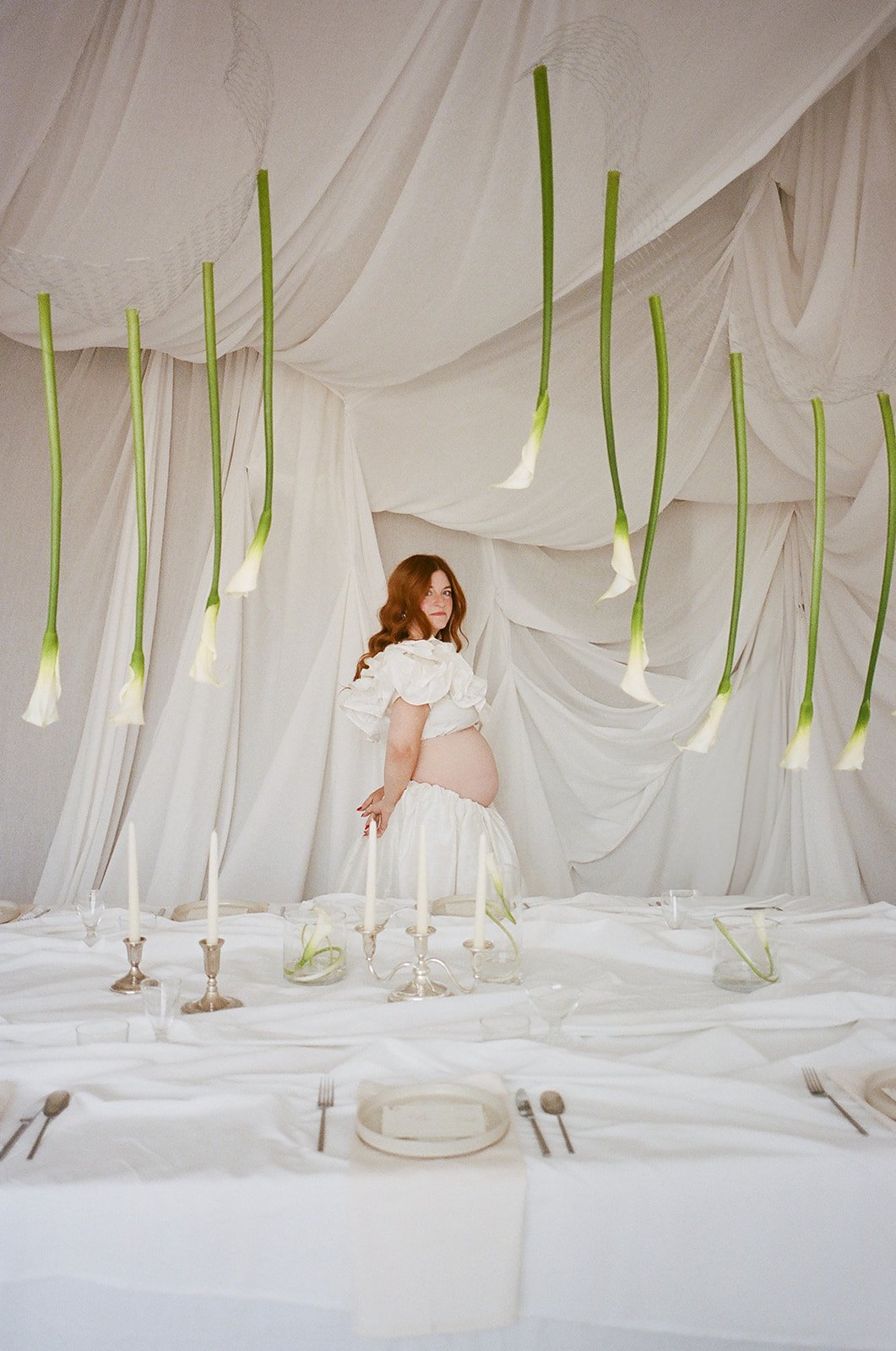 Chic Modern Baby Shower in a Cloud with layers of white draped fabric, simple calla lily centerpieces,  silver candlesticks, hanging floral installation the cottage rose kansas city florist crossroads white set