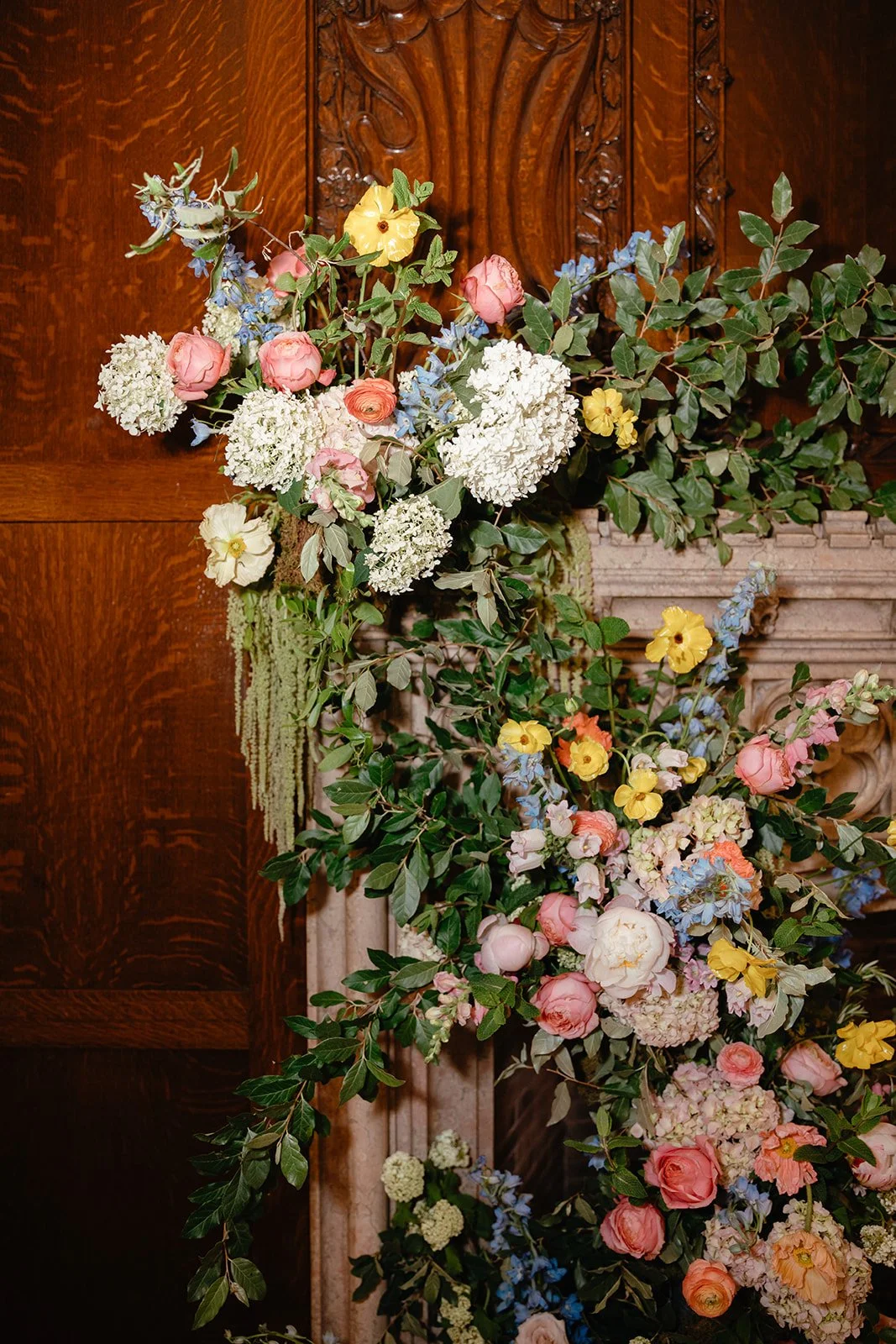 candlelit whimiscal spring garden wedding pastel color palette same sex wedding ceremony fireplace floral installation aisle flowers downtown kc hotel kansas city the cottage rose kansas city wedding florist crossroads