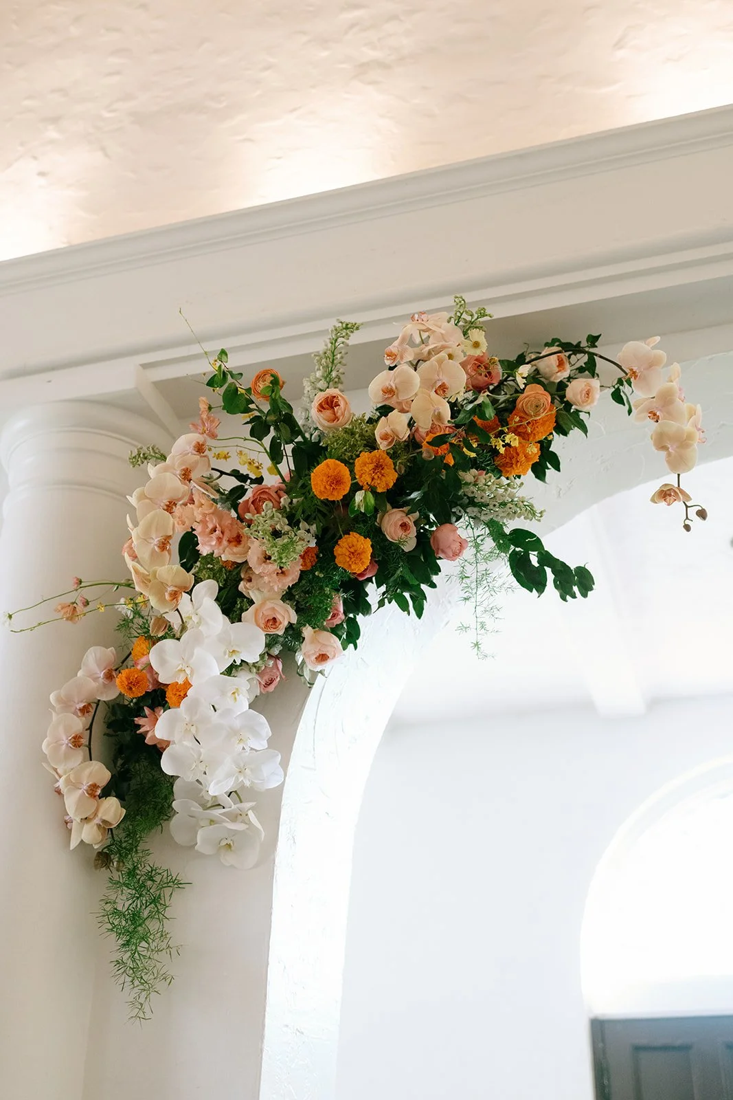 colorful flower filled october wedding in midtown kansas city la villa bridal bouquet wedding bouquet wedding flowers orchids garden roses ranunculus the cottage rose kansas city wedding florist crossroads ceremony hanging flower arrangement