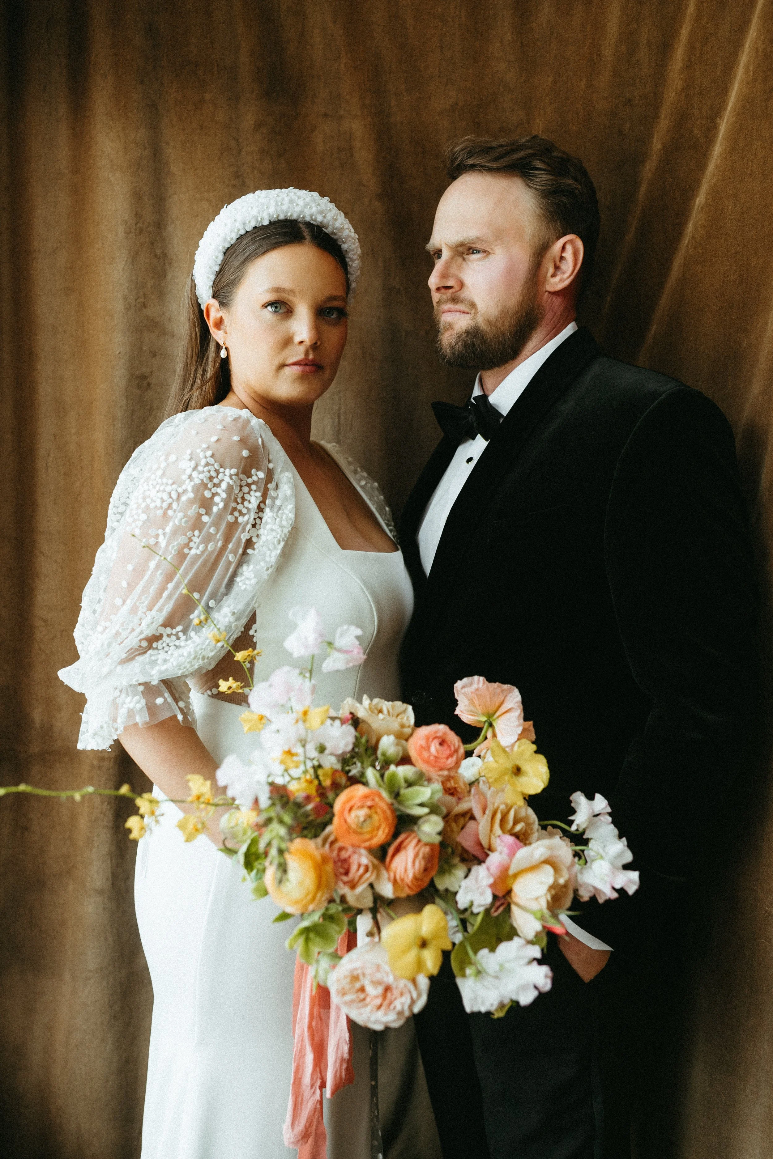 Bride and groom portrait dark draped faric backdrop large lush spring bridal bouquet modern bridal style the grand hall downtown kc the cottage rose kansas city wedding florist crossroads