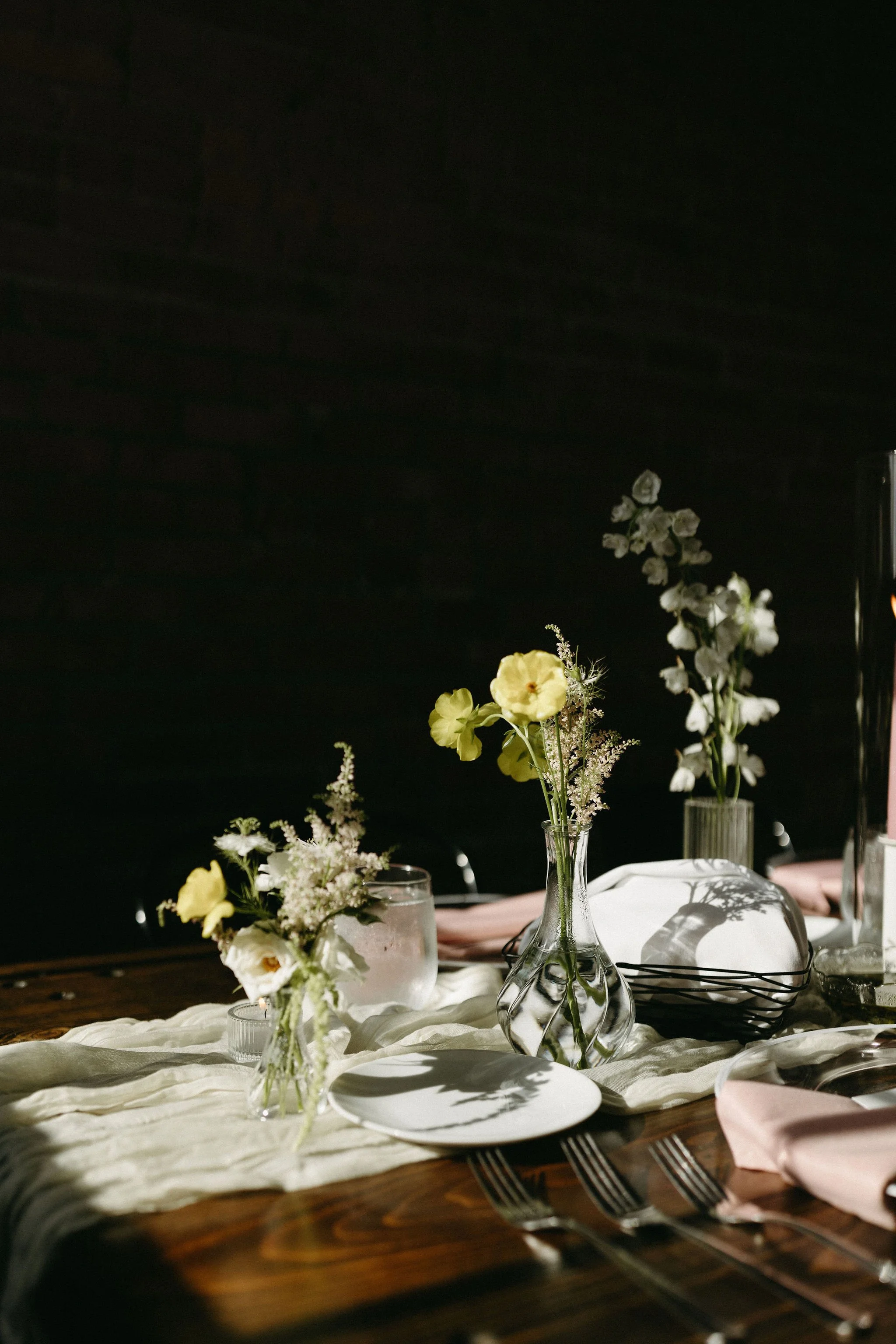 modern spring garden wedding warm color palette yellow peach lilac the cottage rose kansas city florist crossroads powell garden reception hanging greenery bud vases taper candles ikebana flower arrangements centerpieces