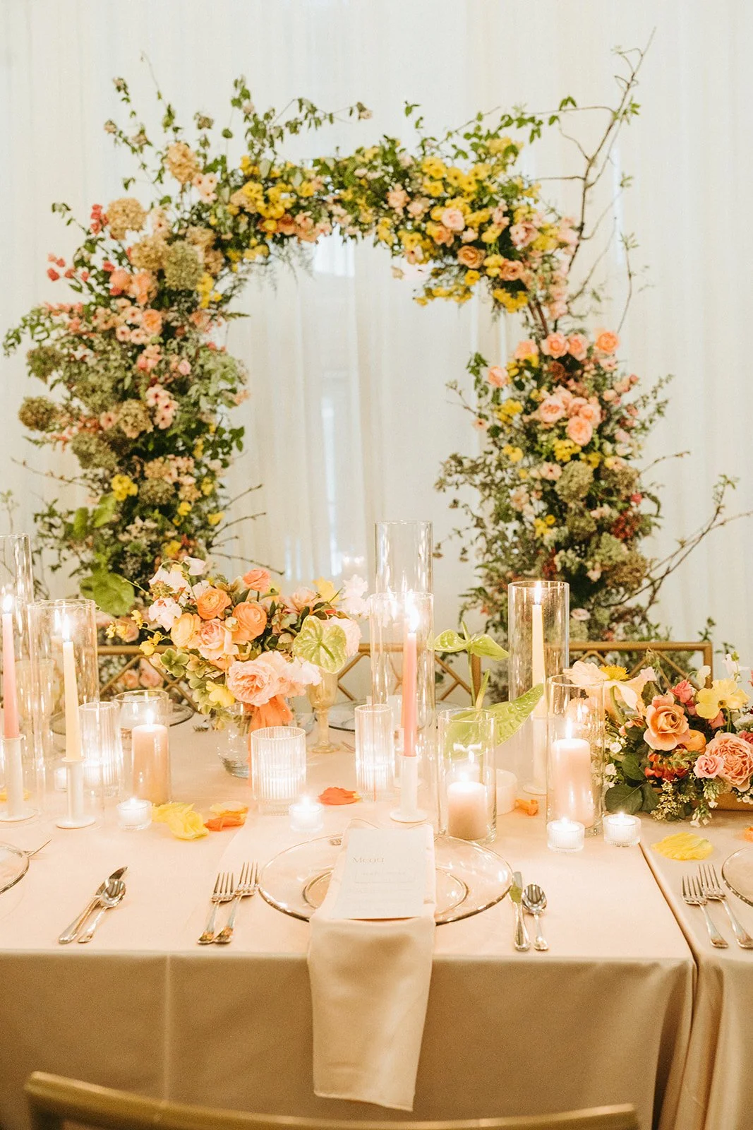 reception flowers large lush floral arch ceremony backdrop head table flowers and candlesmodern garden wedding flowers  the grand hall downtown kc the cottage rose kansas city wedding florist crossroads