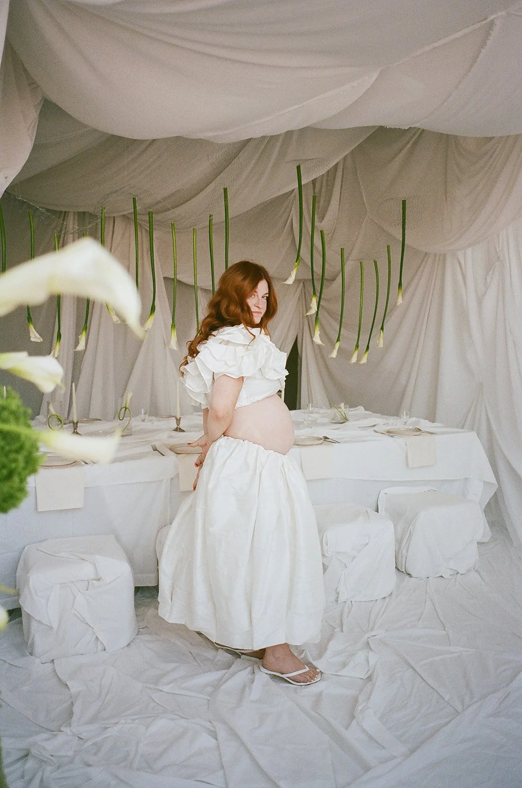 Chic Modern Baby Shower in a Cloud with layers of white draped fabric, simple calla lily centerpieces,  silver candlesticks, hanging floral installation the cottage rose kansas city florist crossroads white set