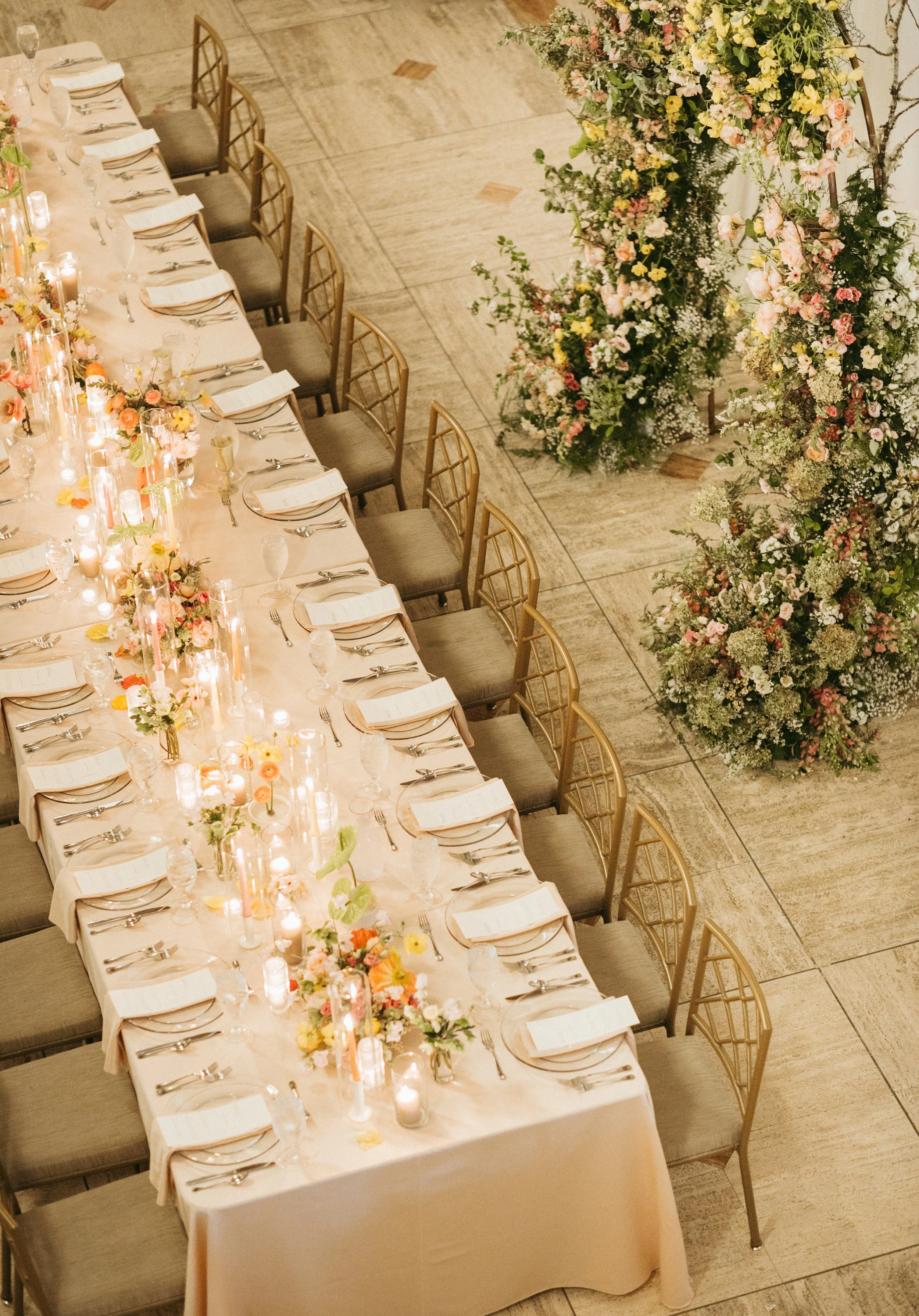 reception flowers large lush floral arch ceremony backdrop head table flowers and candlesmodern garden wedding flowers  the grand hall downtown kc the cottage rose kansas city wedding florist crossroads