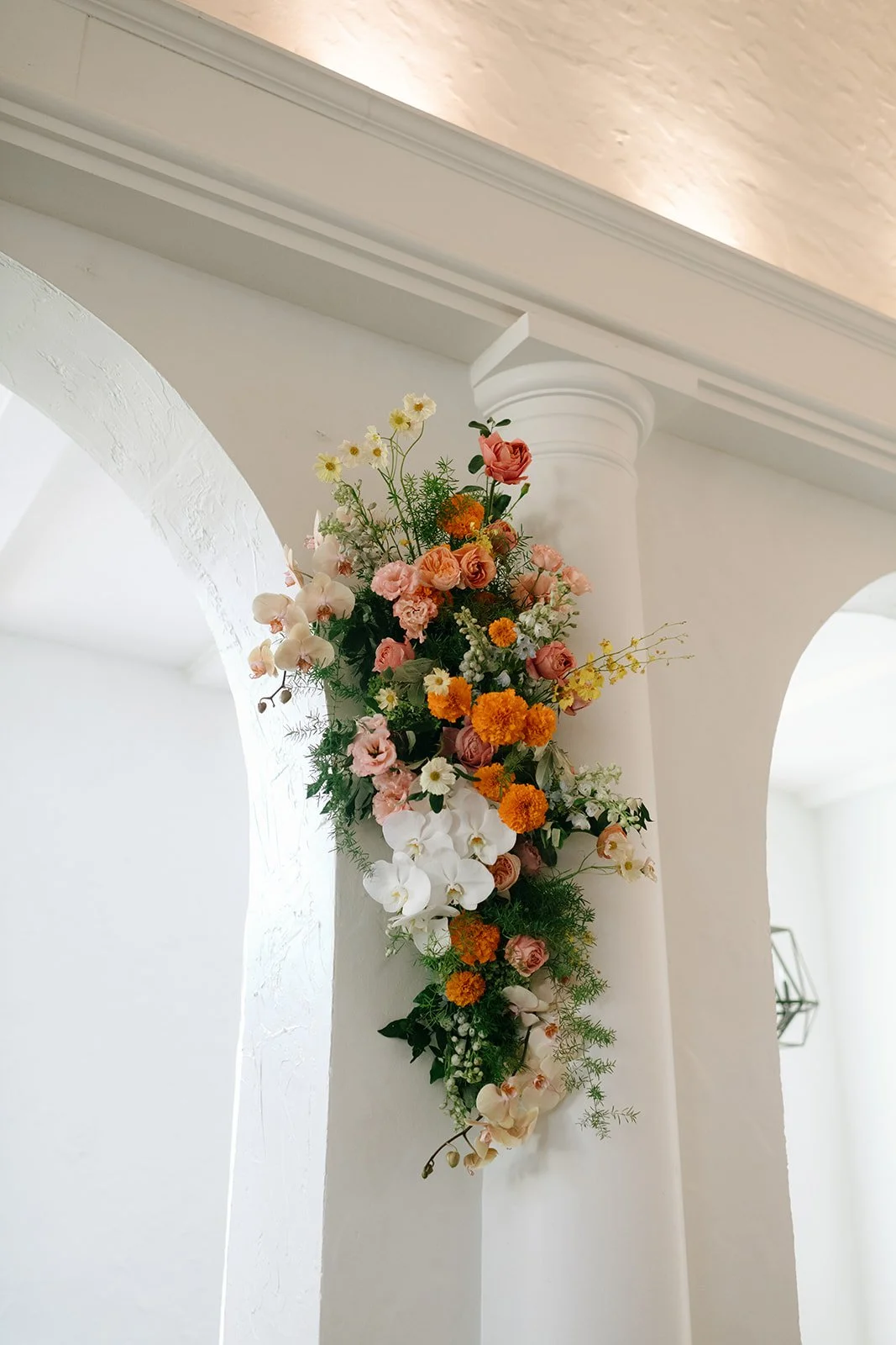 colorful flower filled october wedding in midtown kansas city la villa bridal bouquet wedding bouquet wedding flowers orchids garden roses ranunculus the cottage rose kansas city wedding florist crossroads ceremony hanging flower arrangement