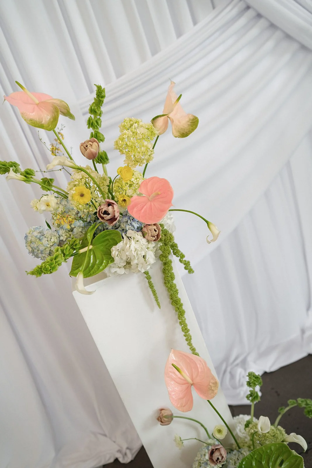 Sculptural modern spring wedding pedestal floral installation anthurium amaranth midtown la villa spring flowers the cottage rose kansas city wedding florist crossroads ceremony decor