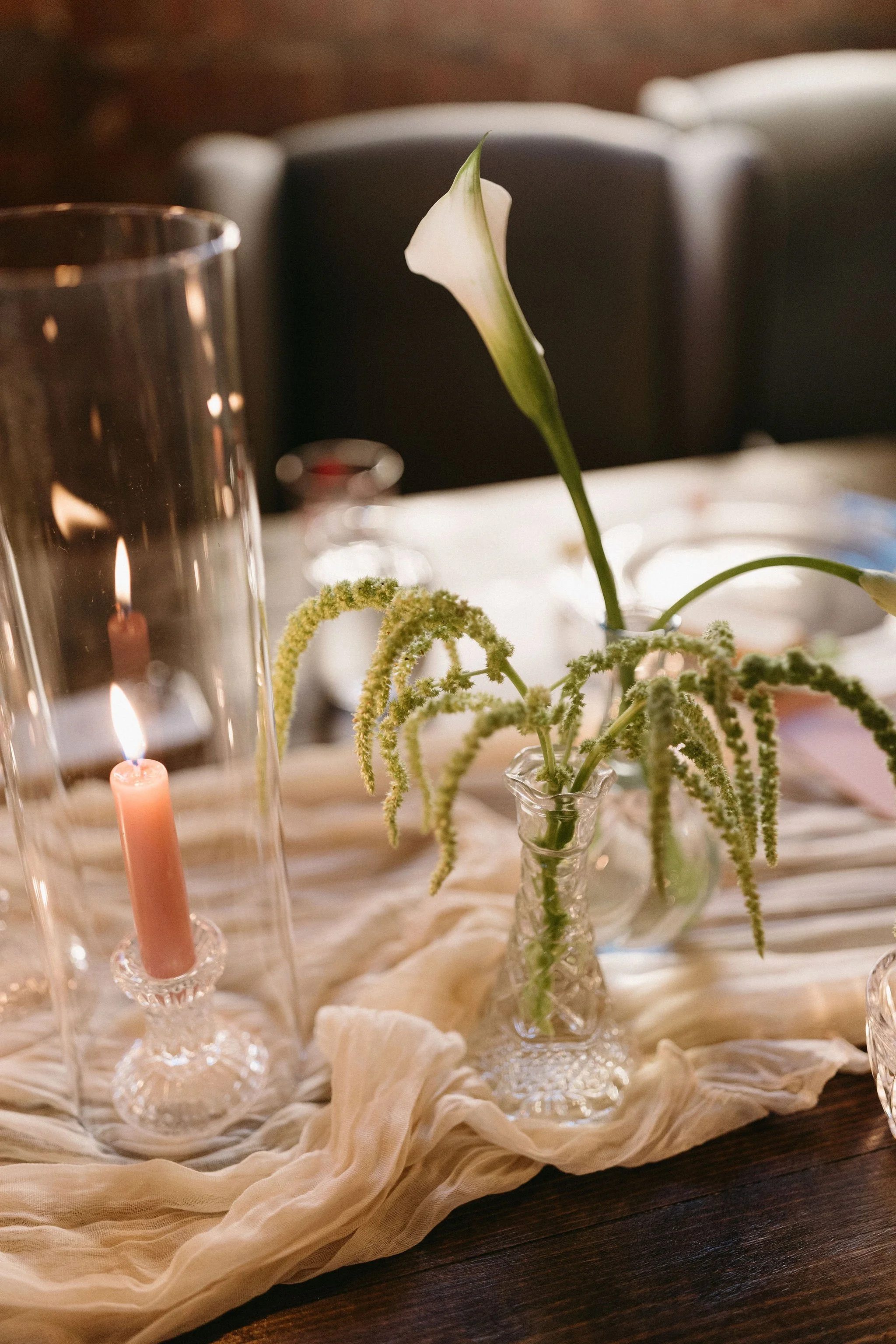 modern spring garden wedding warm color palette yellow peach lilac the cottage rose kansas city florist crossroads powell garden reception hanging greenery bud vases taper candles ikebana flower arrangements centerpieces calla lily hanging amaranth