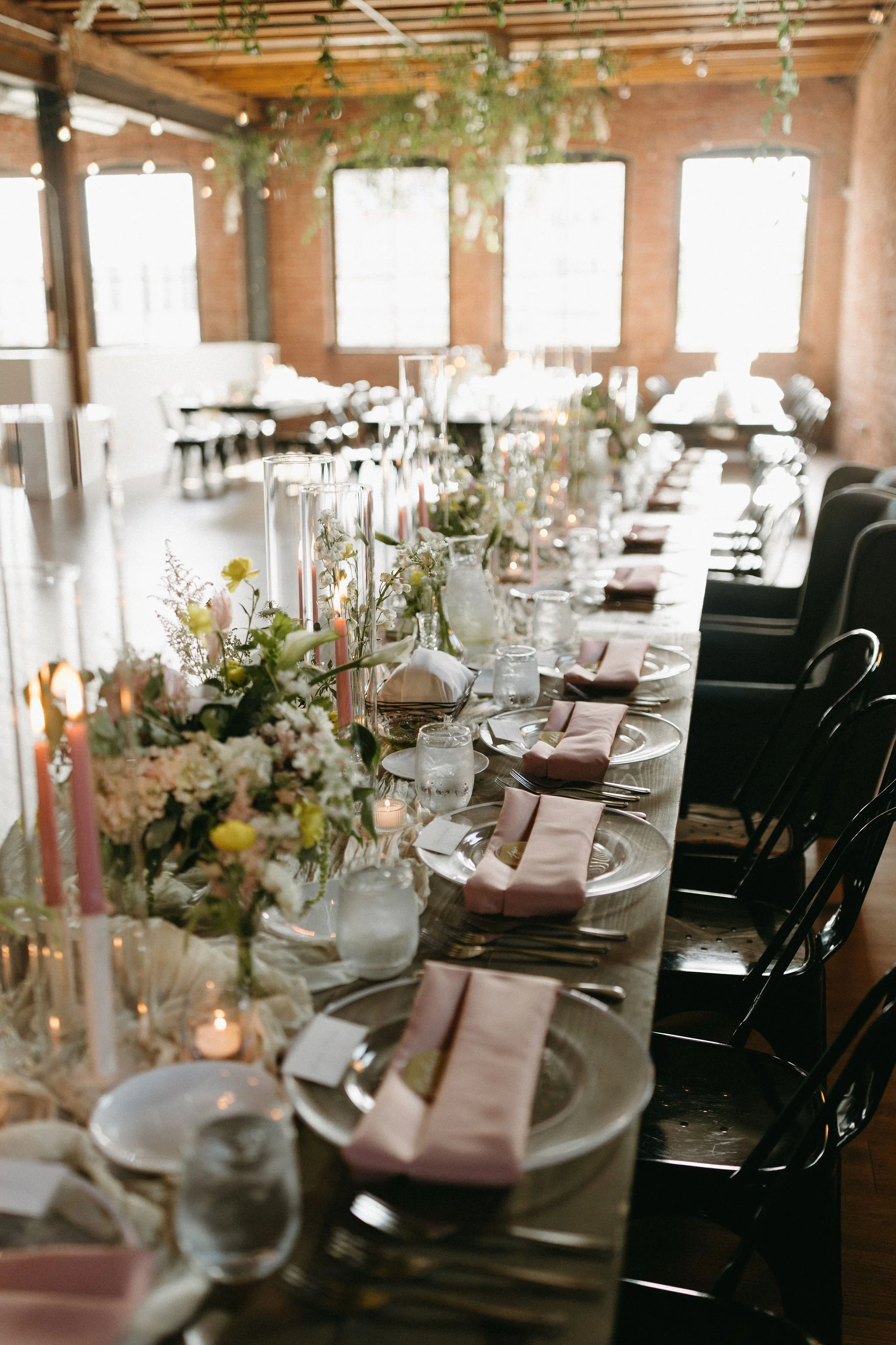 modern spring garden wedding warm color palette yellow peach green the cottage rose kansas city florist crossroads powell garden reception hanging greenery bud vases taper candles ikebana flower arrangements centerpieces head table decor