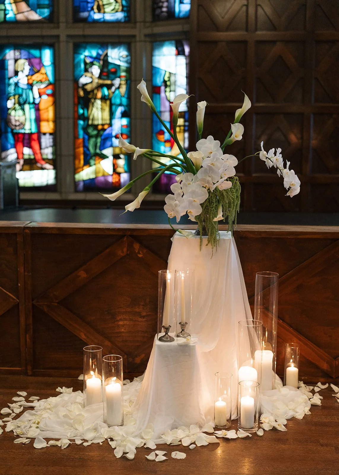 Modern chic november fall wedding downtown hotel kansas city rose petals orchids calla lilies amaranth wedding ceremony arrangement pedestal candles fabric altar installation the cottage rose kansas city wedding florist crossroads