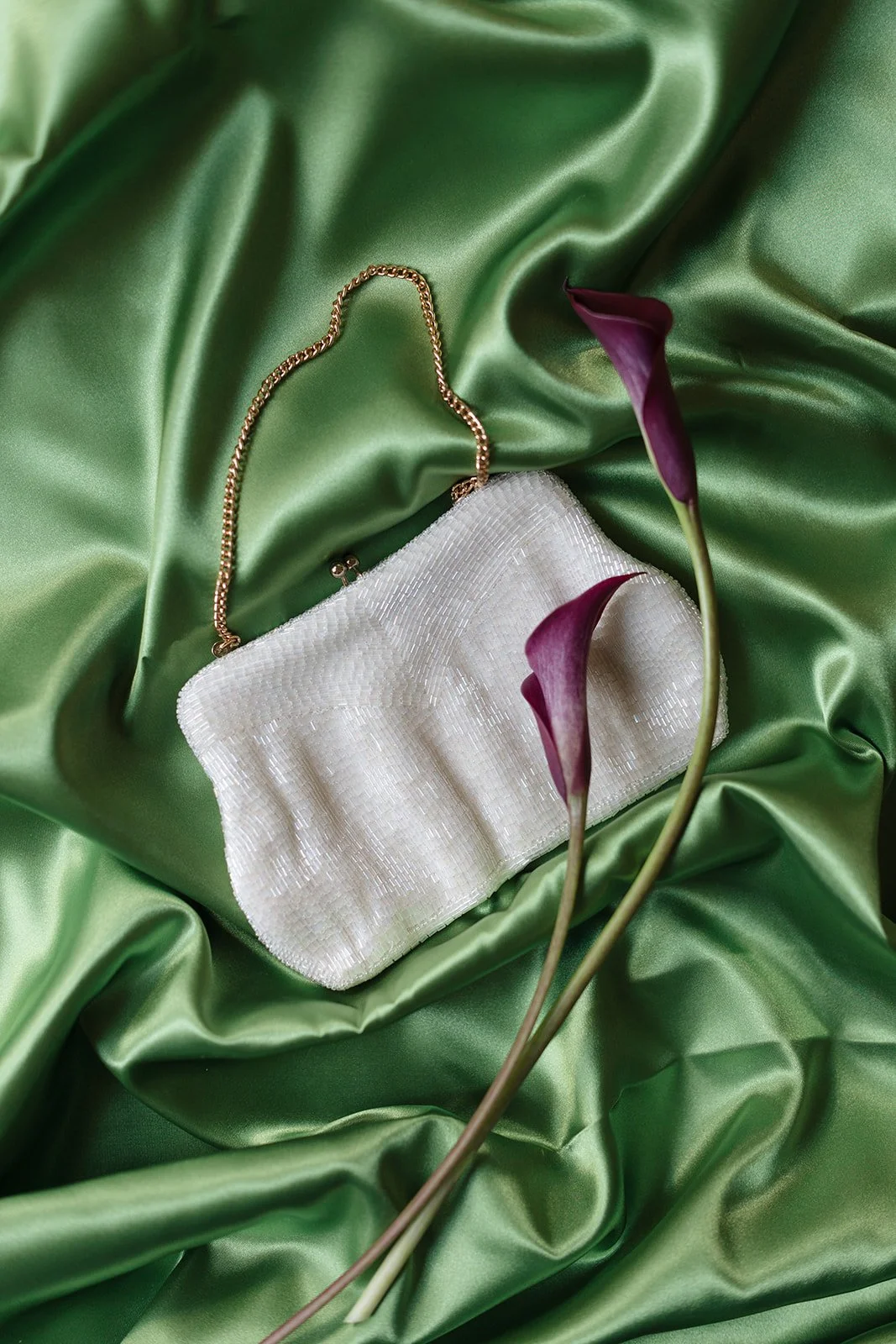 Modern chic november fall wedding downtown hotel kansas city calla lily wedding purse flat lay detail shot the cottage rose kansas city wedding florist crossroads
