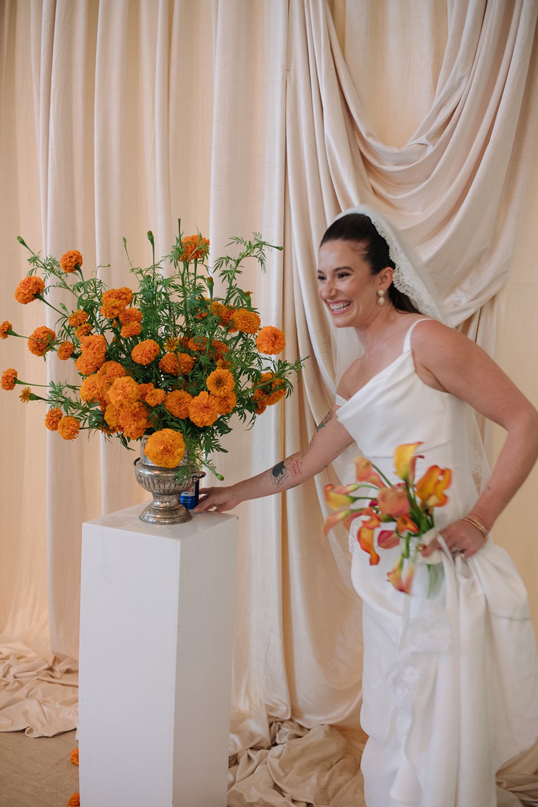 Modern september wedding ceremony ivory draped fabric orange and yellow color palette floral pedestals marigolds library wedding ceremony bridal portrait  the cottage rose kansas city wedding florist crossroads hotel kansas city wedding