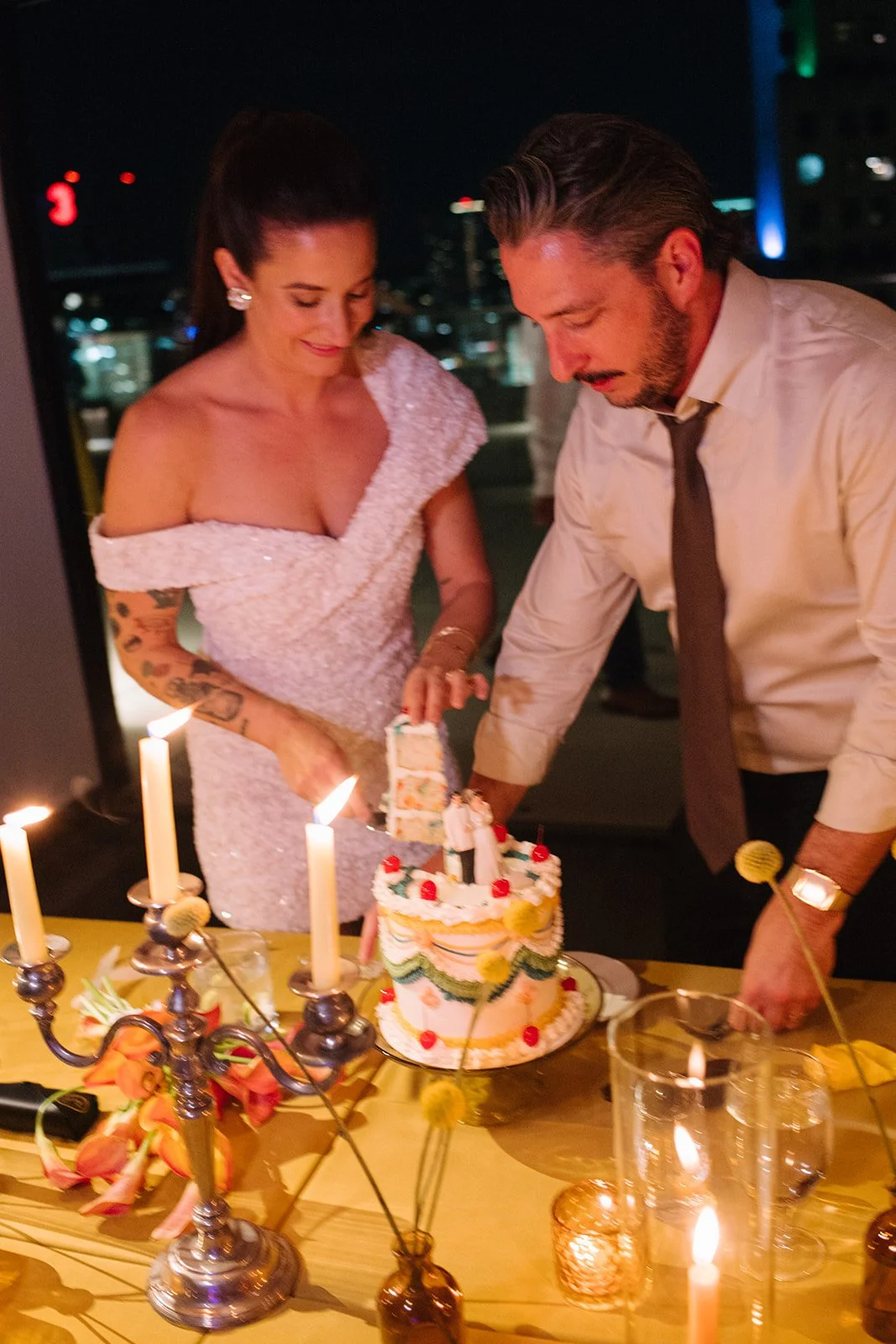 Modern september wedding reception orange and yellow color palette craspedia bud vases centerpieces silver candelabra  the cottage rose kansas city wedding florist crossroads hotel kansas city wedding orange marigold ikebana head table candles cake