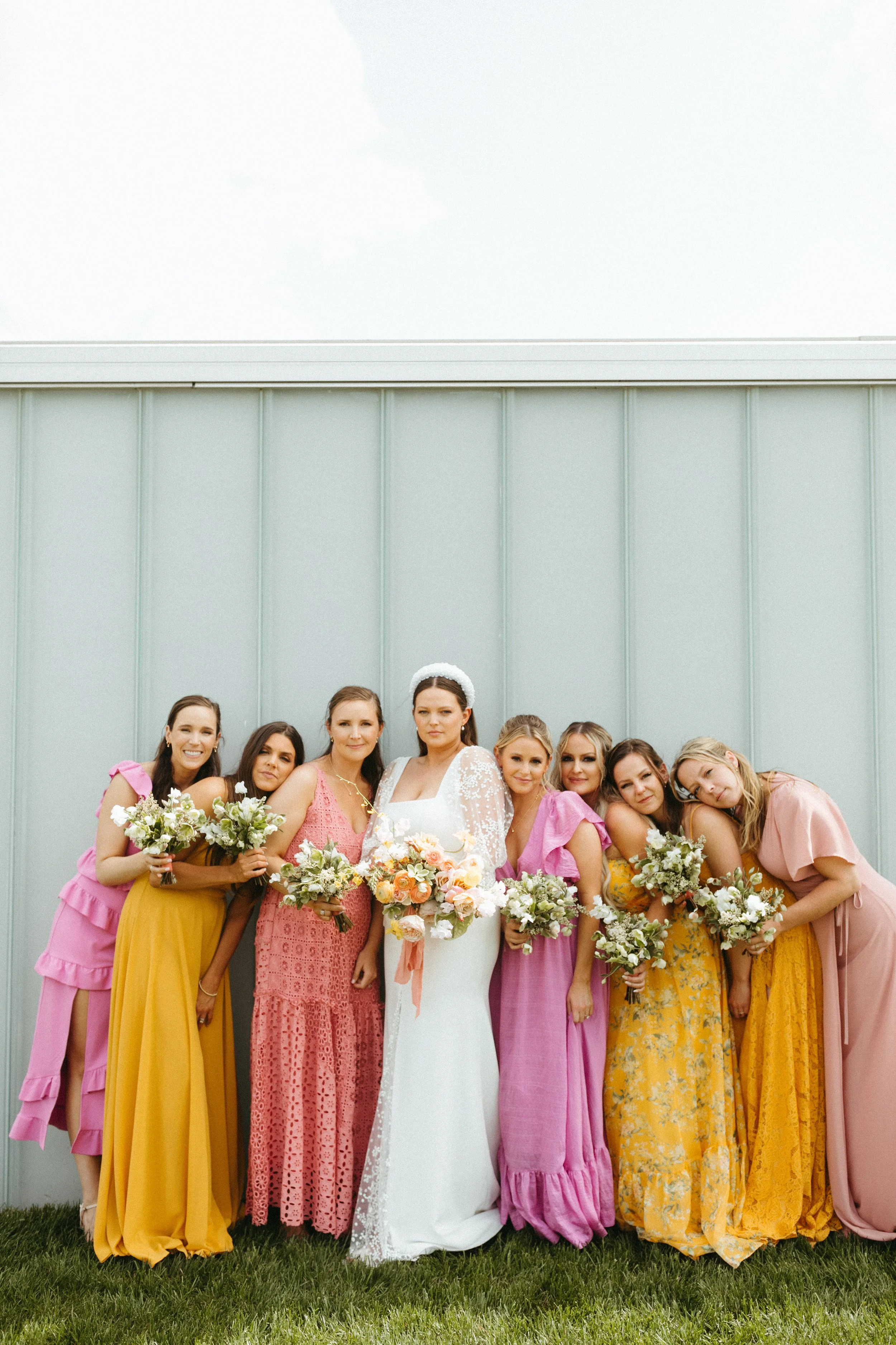 Bride and bridesmaids with bouquets nelson atkins backdrop large lush spring bridal bouquet modern bridal style the grand hall downtown kc the cottage rose kansas city wedding florist crossroads