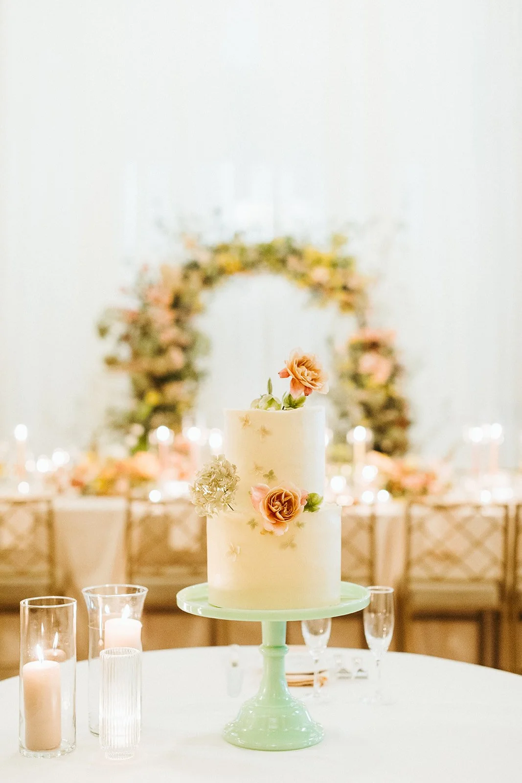 reception flowers large lush floral arch ceremony backdrop head table flowers and candlesmodern garden wedding flowers  the grand hall downtown kc the cottage rose kansas city wedding florist crossroads two tier cake floral accents