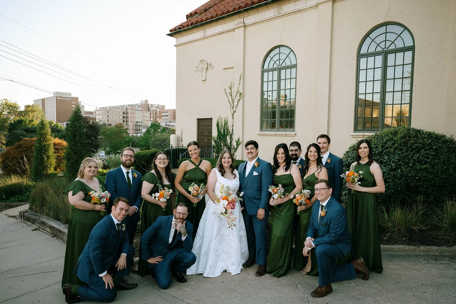 colorful flower filled october wedding in midtown kansas city la villa bridal bouquet wedding bouquet wedding flowers orchids garden roses ranunculus the cottage rose kansas city wedding florist crossroads bride and bridesmaids green dresses groom