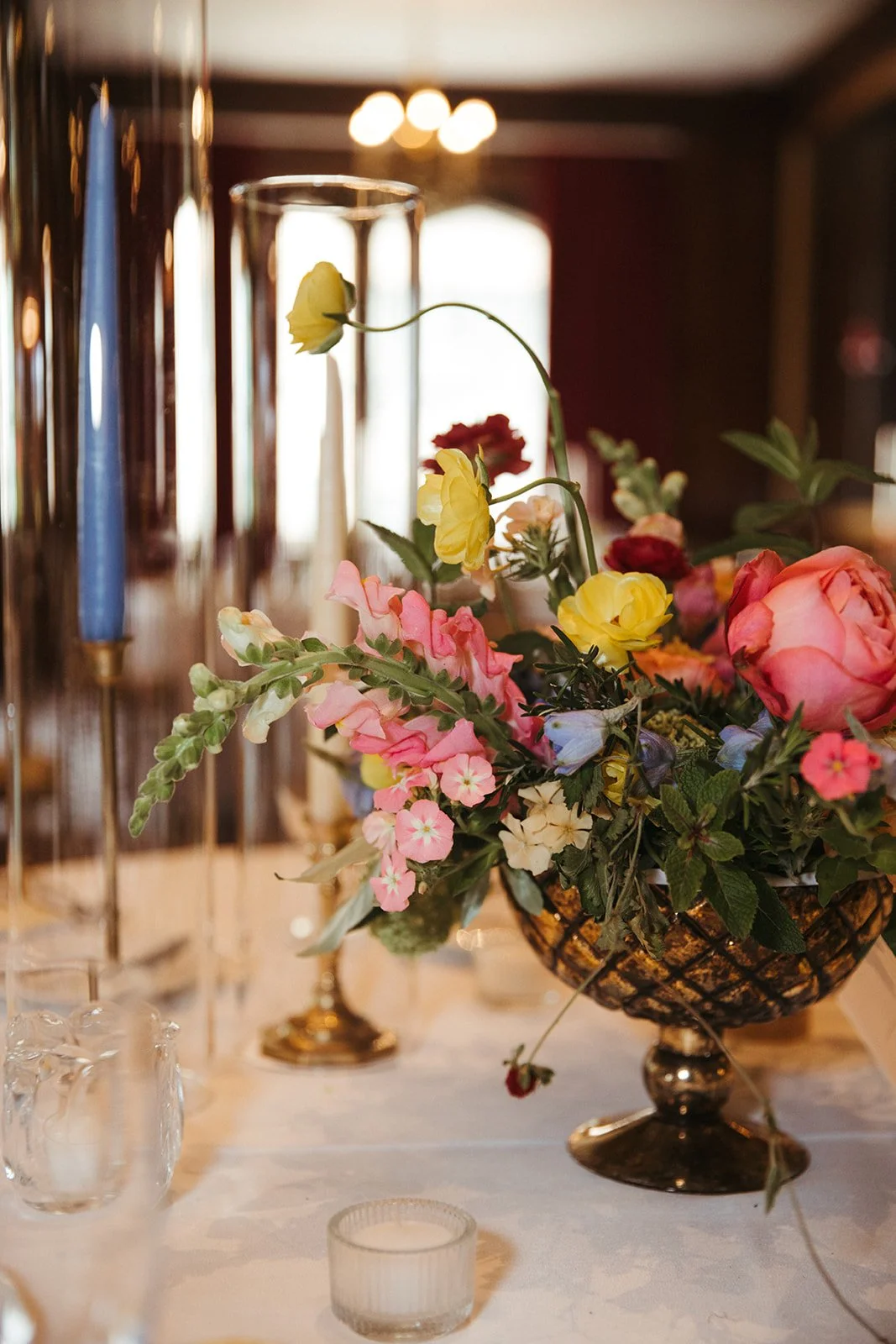 candlelit whimiscal spring garden wedding pastel color palette same sex wedding reception table floral centerpieces downtown kc hotel kansas city the cottage rose kansas city wedding florist crossroads