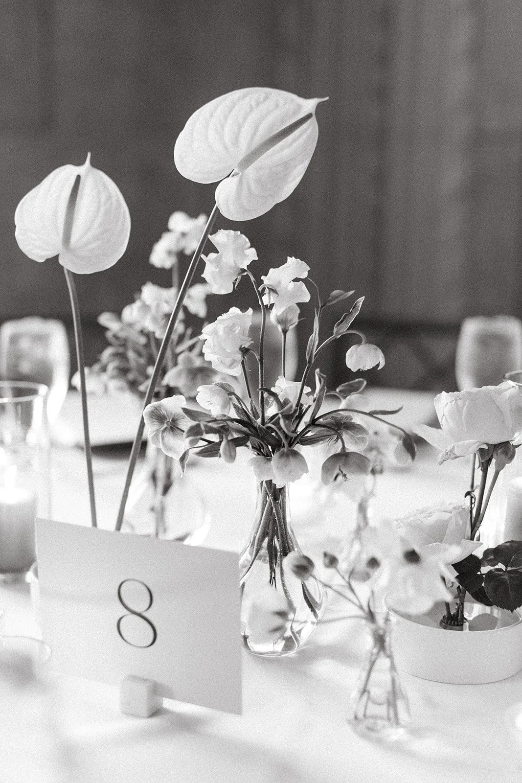 reception flowers centerpieces art deco ballroom venue flowers and candlesmodern garden wedding flowers  the grand hall downtown kc the cottage rose kansas city wedding florist crossroads bud vases ikebana anthurium black and white photo
