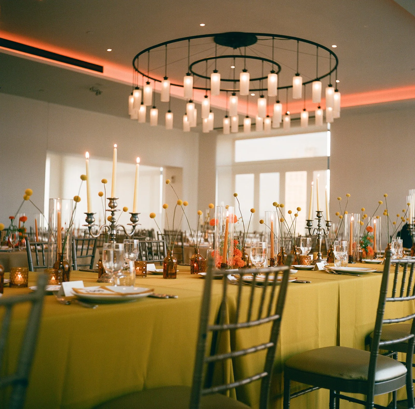 Modern september wedding reception orange and yellow color palette craspedia bud vases centerpieces silver candelabra  the cottage rose kansas city wedding florist crossroads hotel kansas city wedding orange marigold ikebana arrangement head table