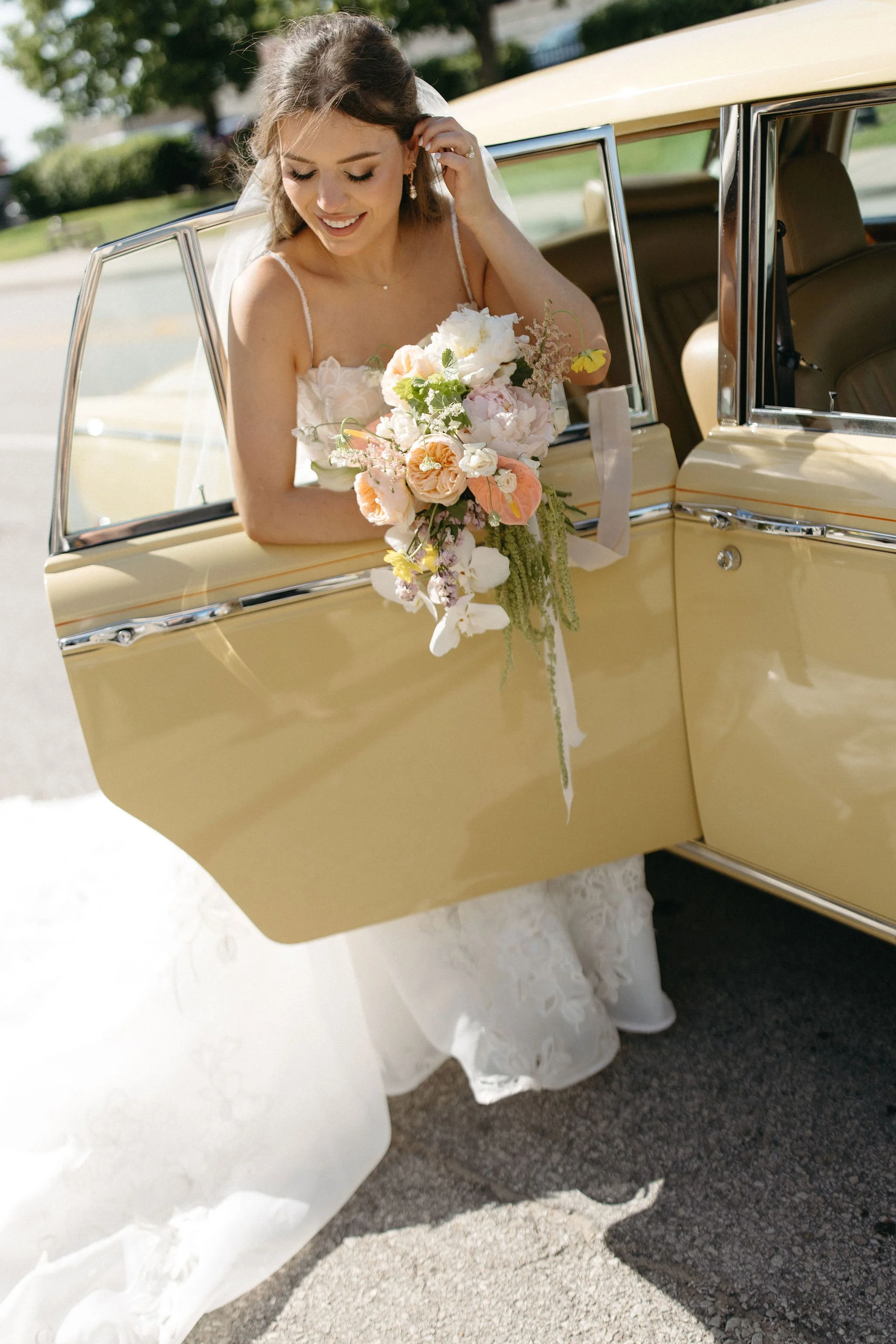 modern spring garden wedding large statement bridal bouquet bride and groom portraits bridal style the cottage rose kansas city florist crossroads powell garden ceremony vintage car