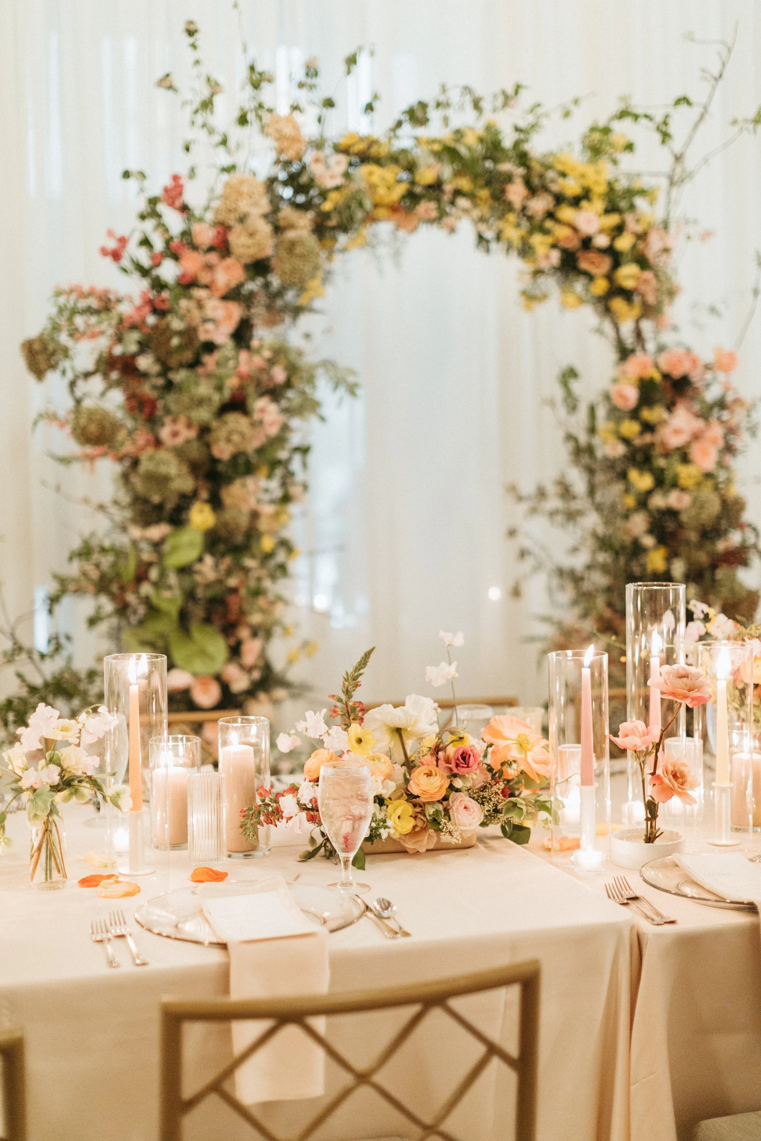 reception flowers large lush floral arch ceremony backdrop head table flowers and candlesmodern garden wedding flowers  the grand hall downtown kc the cottage rose kansas city wedding florist crossroads