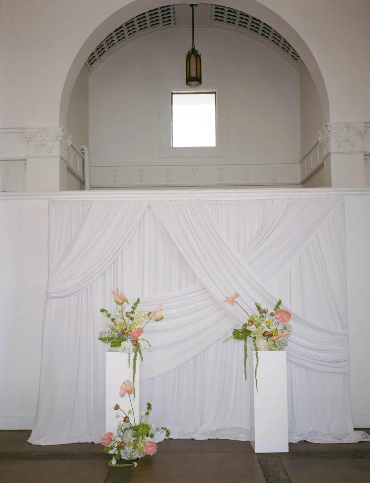 Sculptural modern spring wedding pedestal floral installation anthurium amaranth midtown la villa spring flowers the cottage rose kansas city wedding florist crossroads ceremony decor