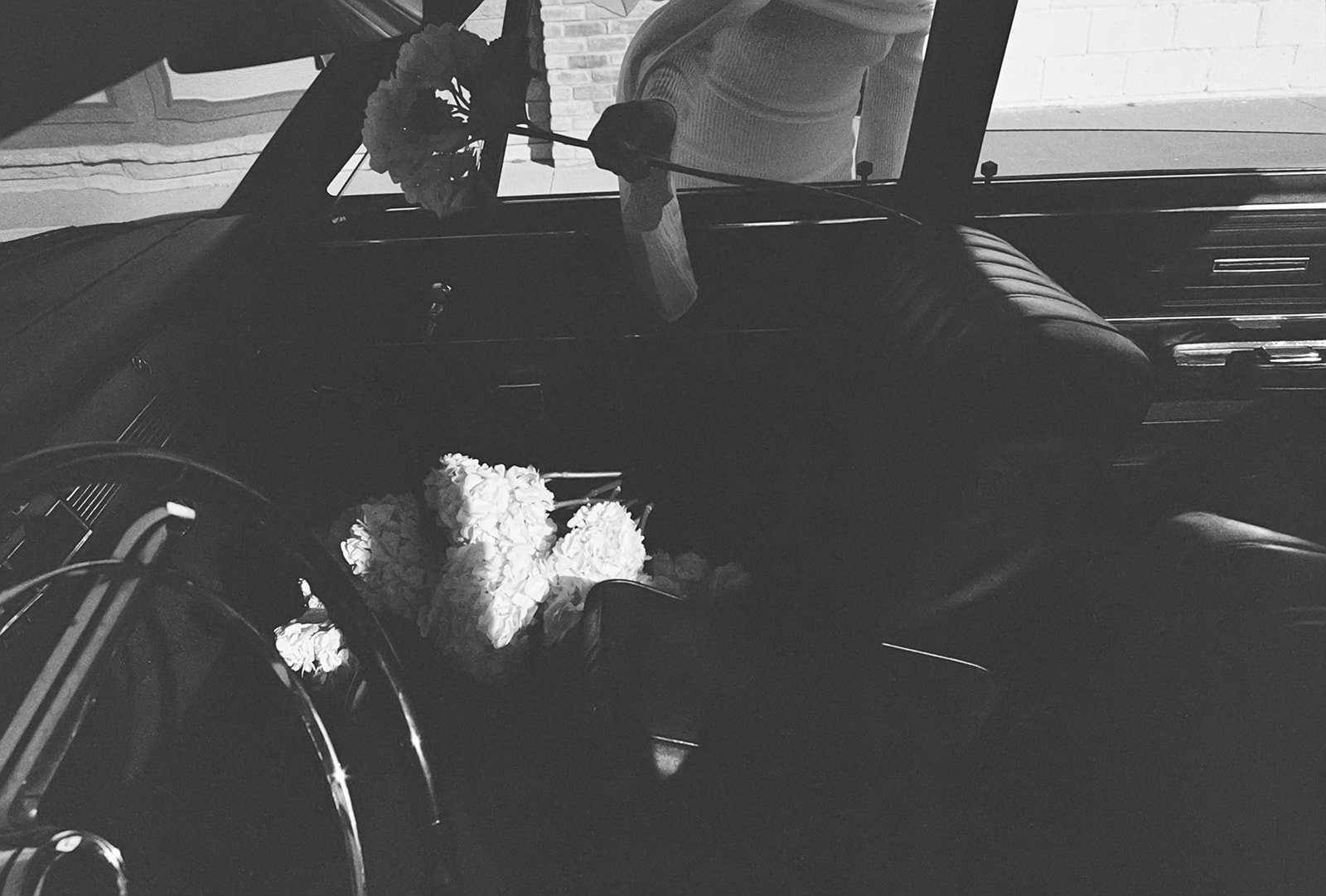 film image model in vintage car holding hydrangea the cottage rose kansas city wedding florist crossroads branding shoot interior designer