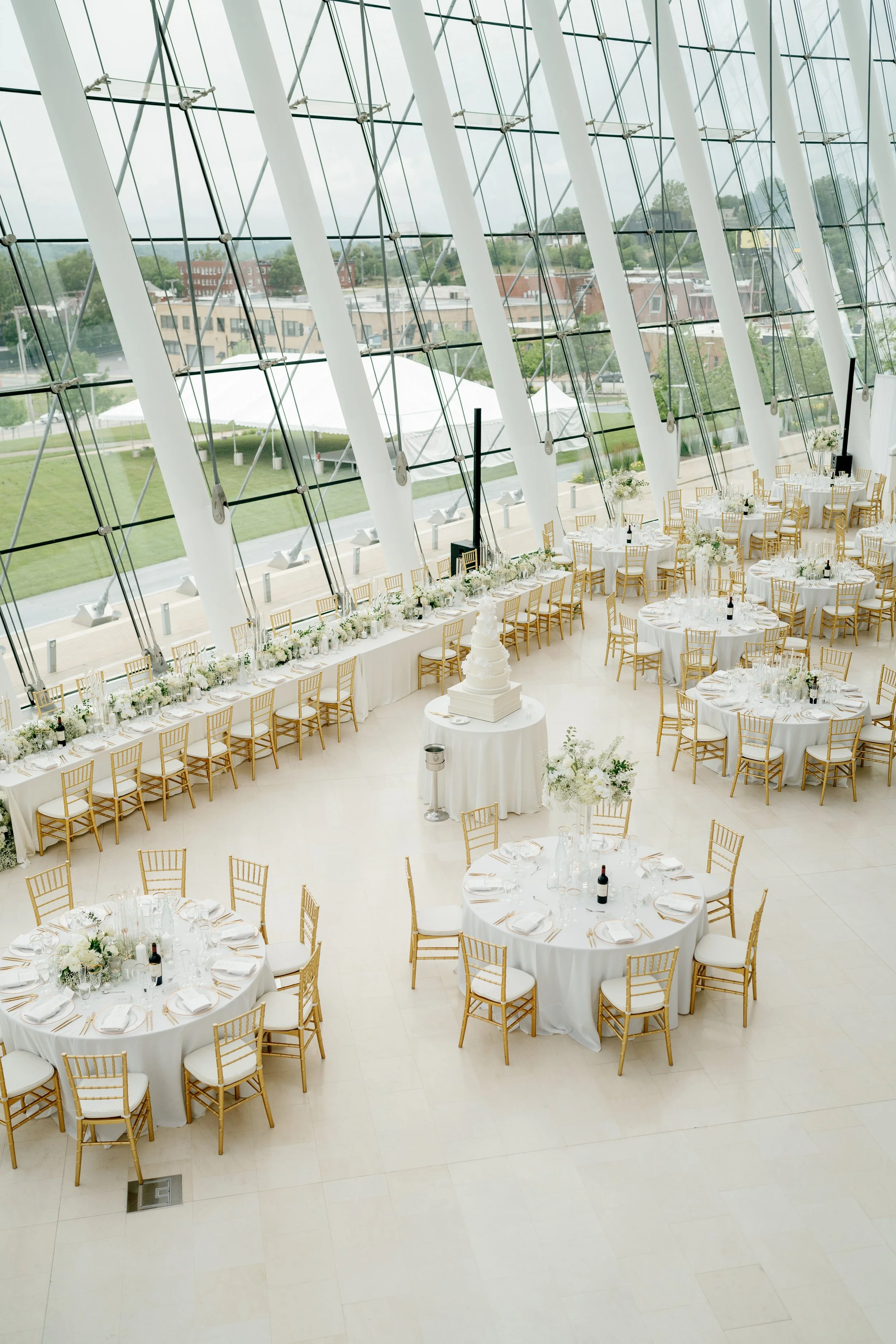 Modern chic spring wedding kauffman center for the performing arts cloud dancer inspiration head table garland tall centerpieces low floral arrangement babys breath orchids calla lilies the cottage rose kansas city wedding florist crossroads