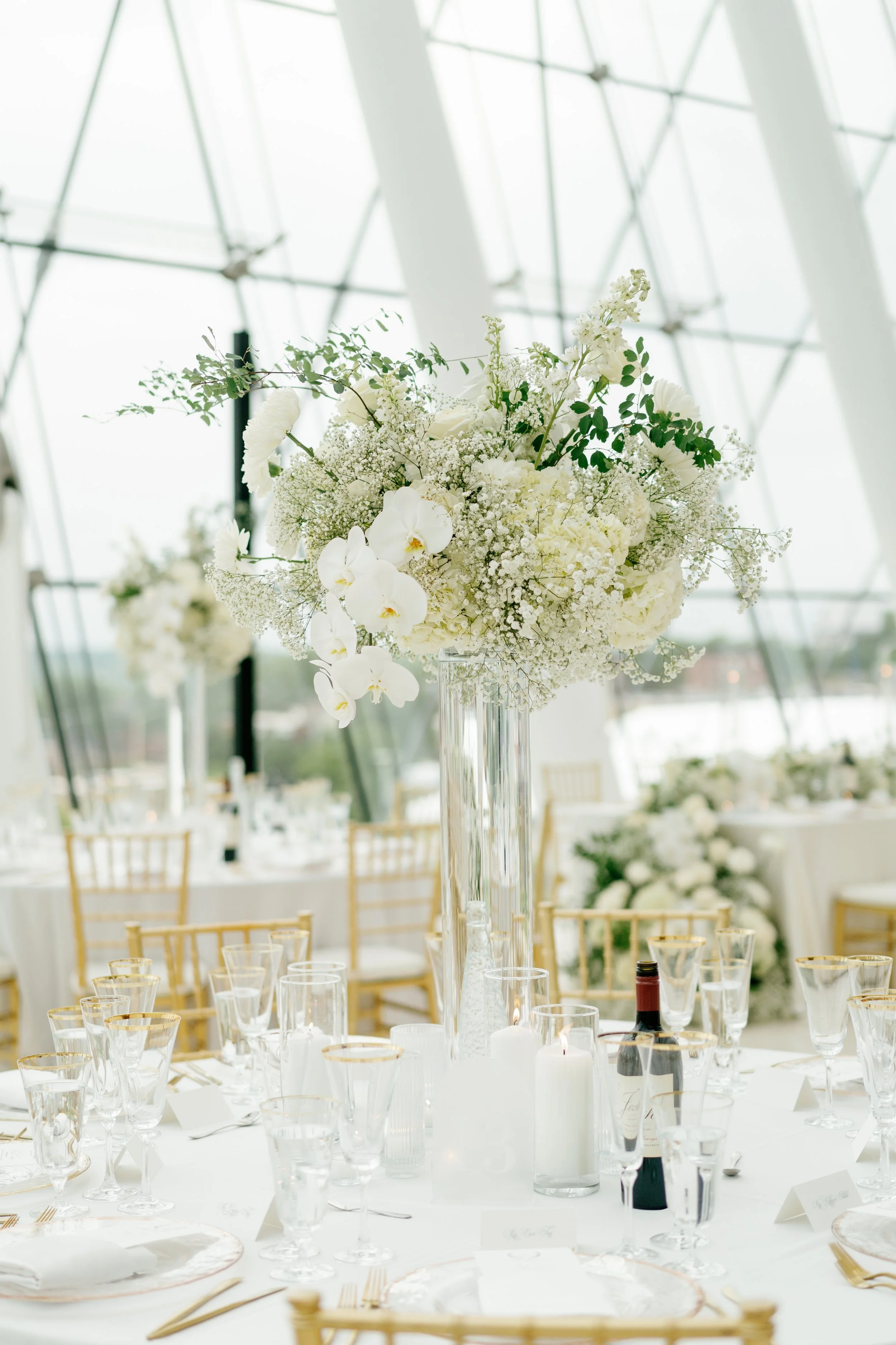 Modern chic spring wedding kauffman center for the performing arts cloud dancer inspiration head table garland tall centerpieces low floral arrangement babys breath orchids calla lilies the cottage rose kansas city wedding florist crossroads