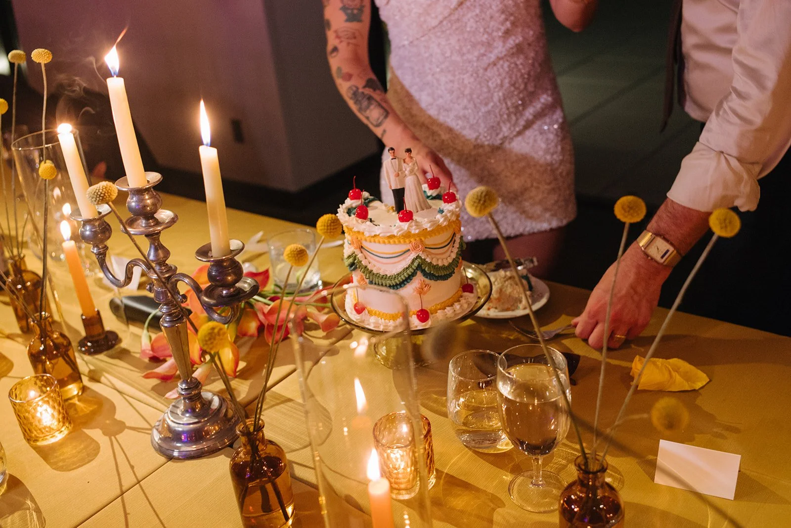 Modern september wedding reception orange and yellow color palette craspedia bud vases centerpieces silver candelabra  the cottage rose kansas city wedding florist crossroads hotel kansas city wedding orange marigold ikebana head table candles cake