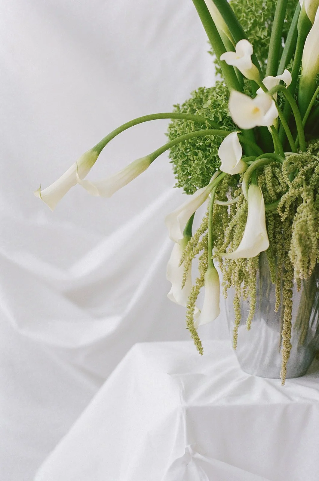 Chic Modern Baby Shower in a Cloud with layers of white draped fabric simple calla lily centerpieces silver vase curly q callas, hanging floral installation the cottage rose kansas city florist crossroads green hydrangea green amaranth