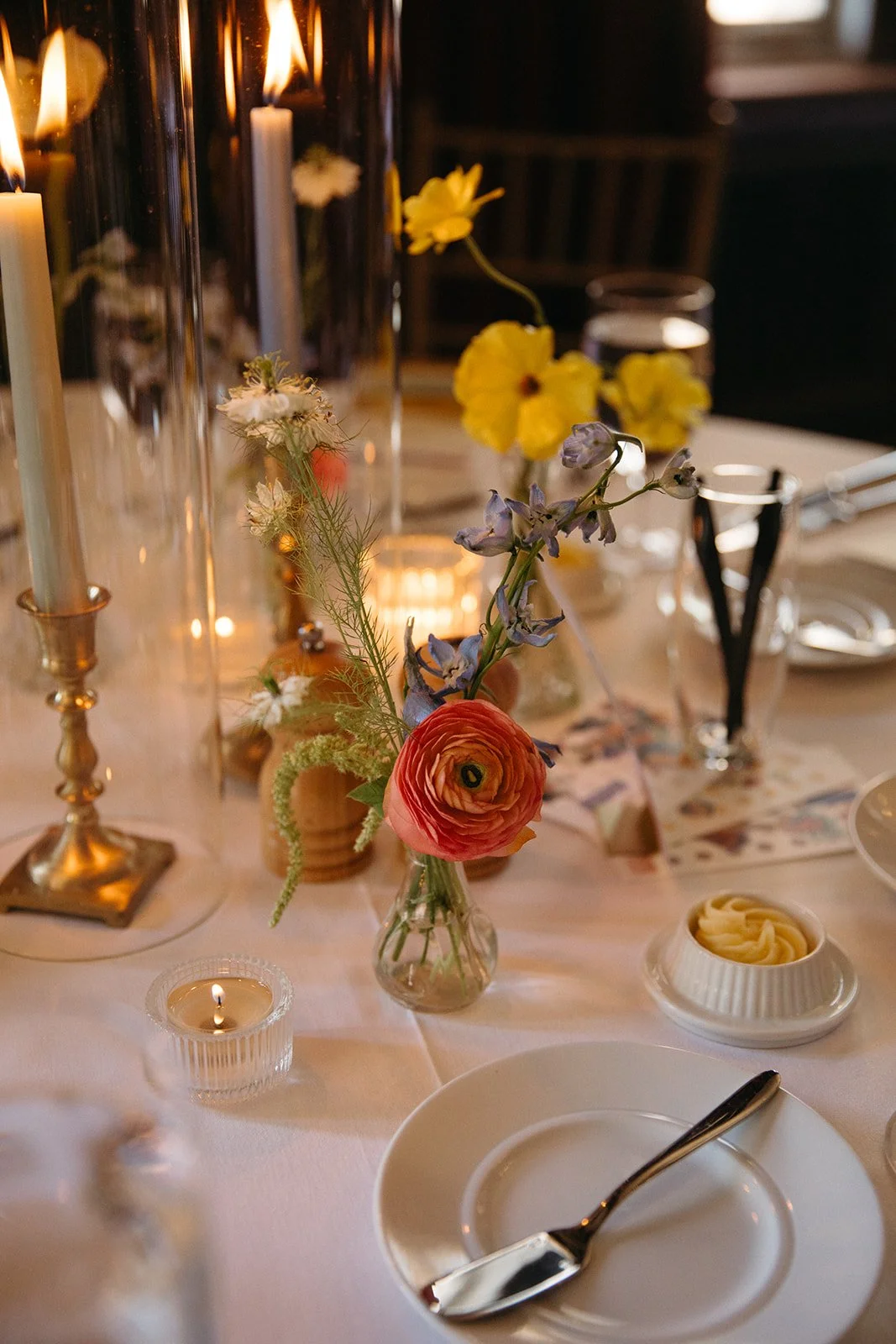 candlelit whimiscal spring garden wedding pastel color palette same sex wedding reception table floral centerpieces downtown kc hotel kansas city the cottage rose kansas city wedding florist crossroads bud vases