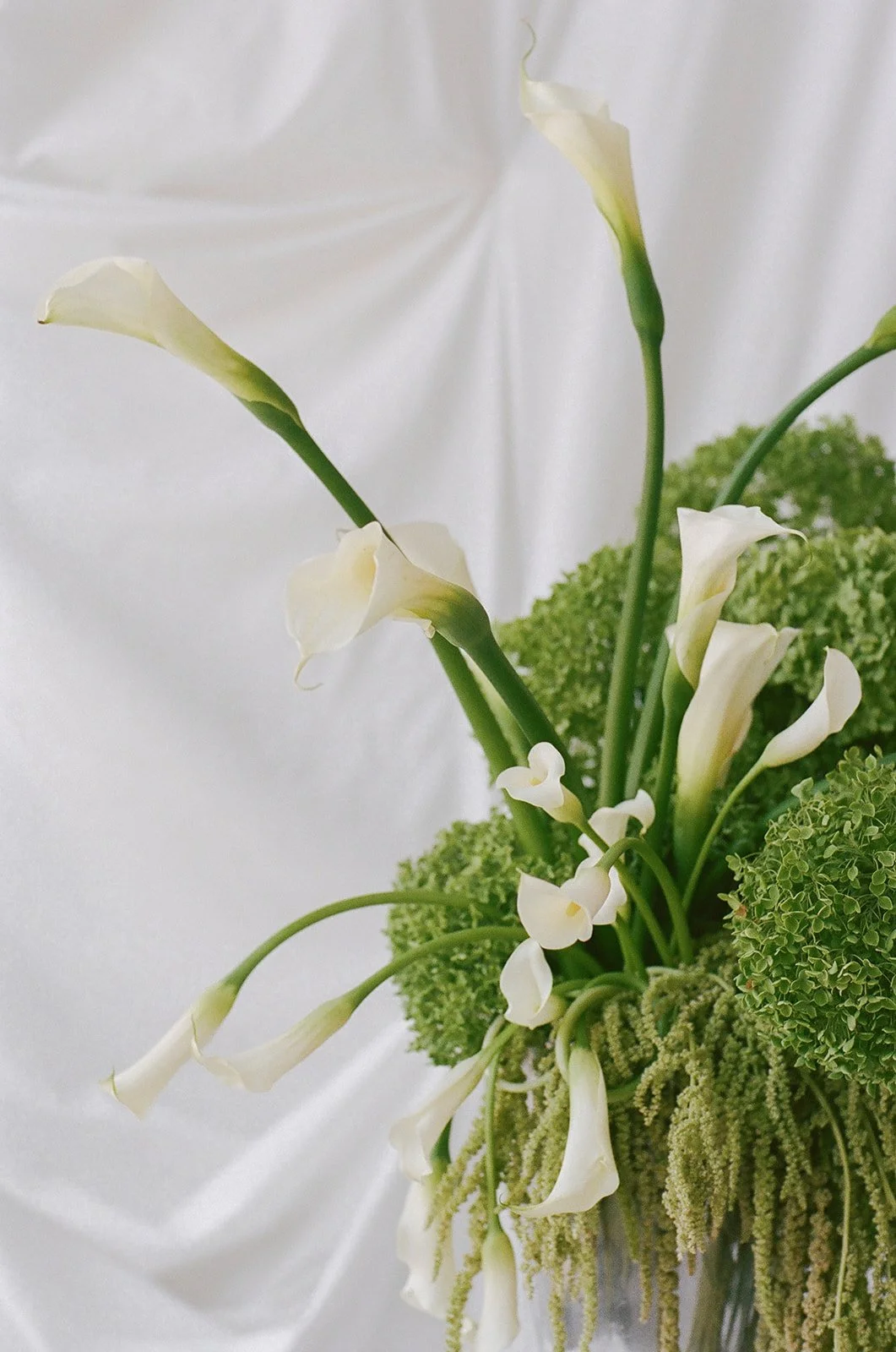 Chic Modern Baby Shower in a Cloud with layers of white draped fabric simple calla lily centerpieces silver vase curly q callas, hanging floral installation the cottage rose kansas city florist crossroads green hydrangea green amaranth