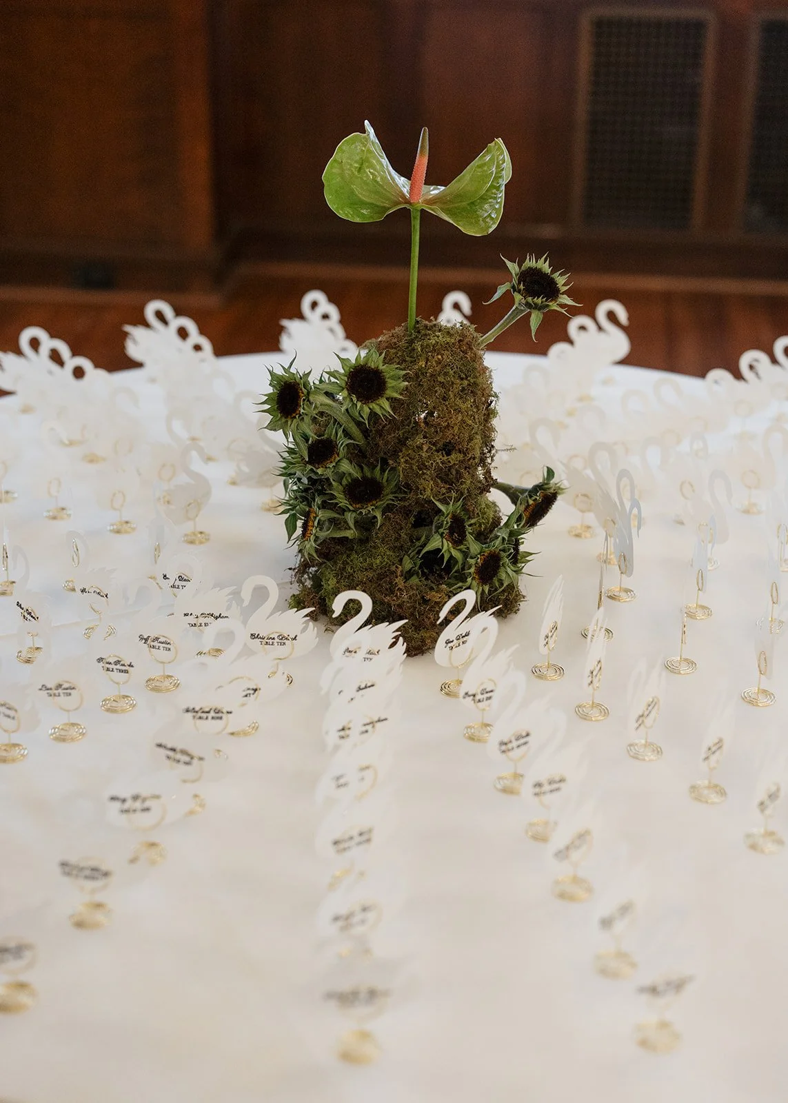 Modern chic november fall wedding downtown hotel kansas city orchids wedding cocktail hour escort card arrangement anthurium sunflower moss mound the cottage rose kansas city wedding florist crossroads