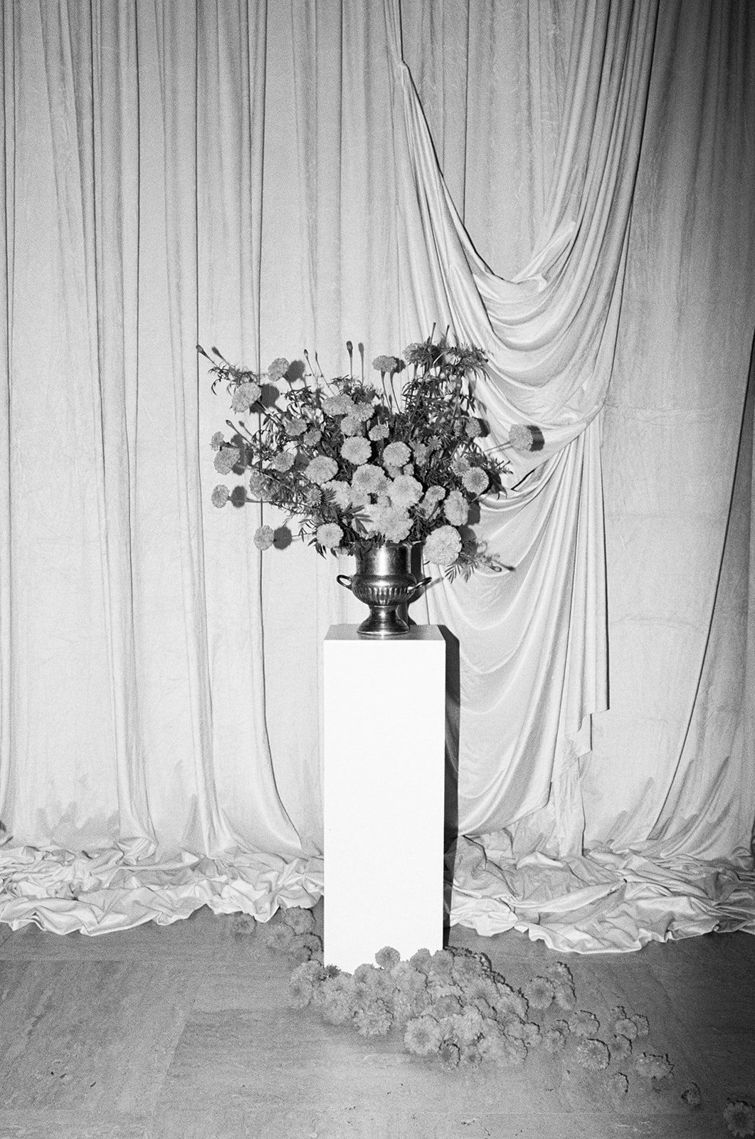 Modern september wedding ceremony ivory draped fabric orange and yellow color palette floral pedestals marigolds library wedding ceremony altar arrangements the cottage rose kansas city wedding florist crossroads hotel kansas city wedding